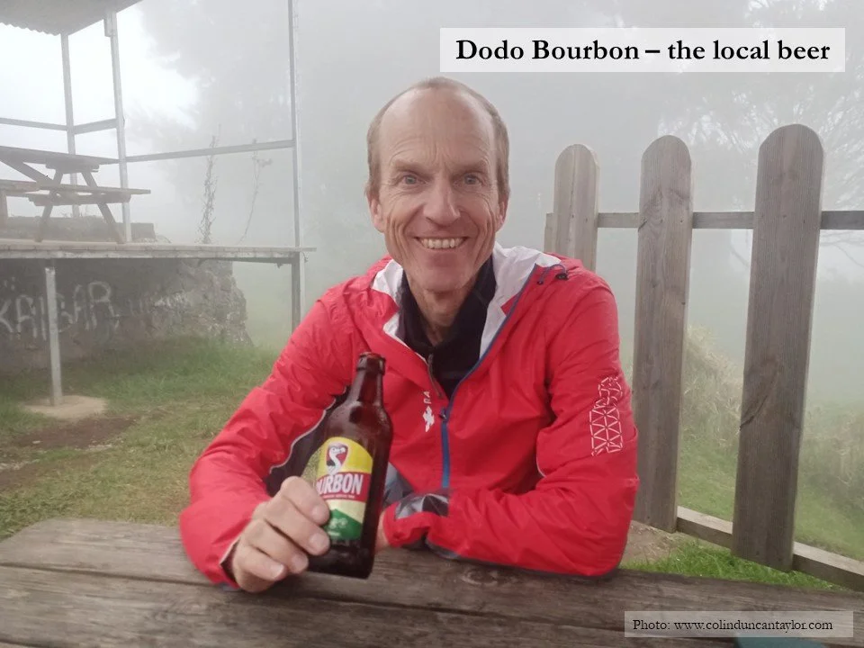 Author Colin Duncan Taylor drinking local beer after hiking in the Cirque de Mafate on the island of La Réunion.