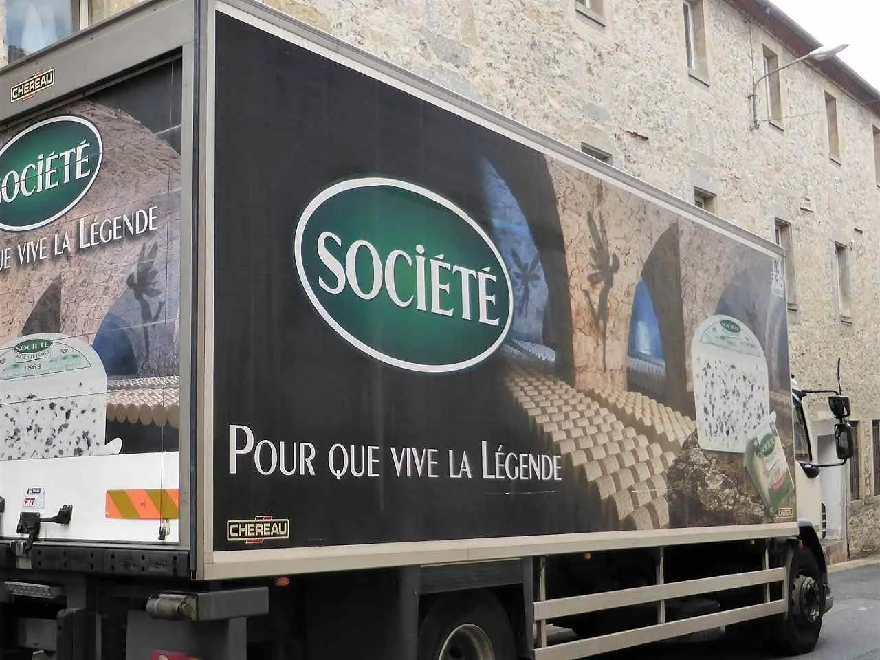A lorry covered in advertising for the cheese company Société Roquefort.