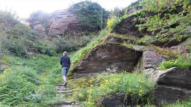 Author Colin Duncan Taylor walks up worn stone stops to the castle in Miraval-Cabardes.