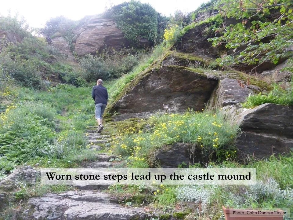 The author Colin Duncan Taylor walks up the worn stone steps leading to the castle of Miraval-Cabardès.