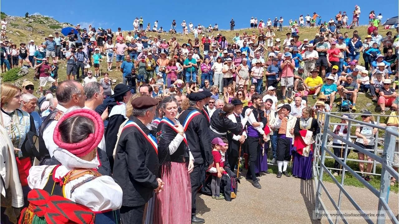 French mayors in their tricolour sashes and their colourfully-dressed Spanish counterparts watch on while a vet selects  three cows from the herd.