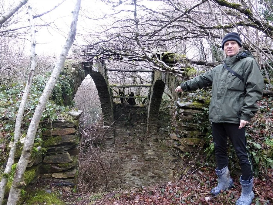 Author Colin Duncan Taylor inspects a ruined ice house near Pradelles-Cabardes.