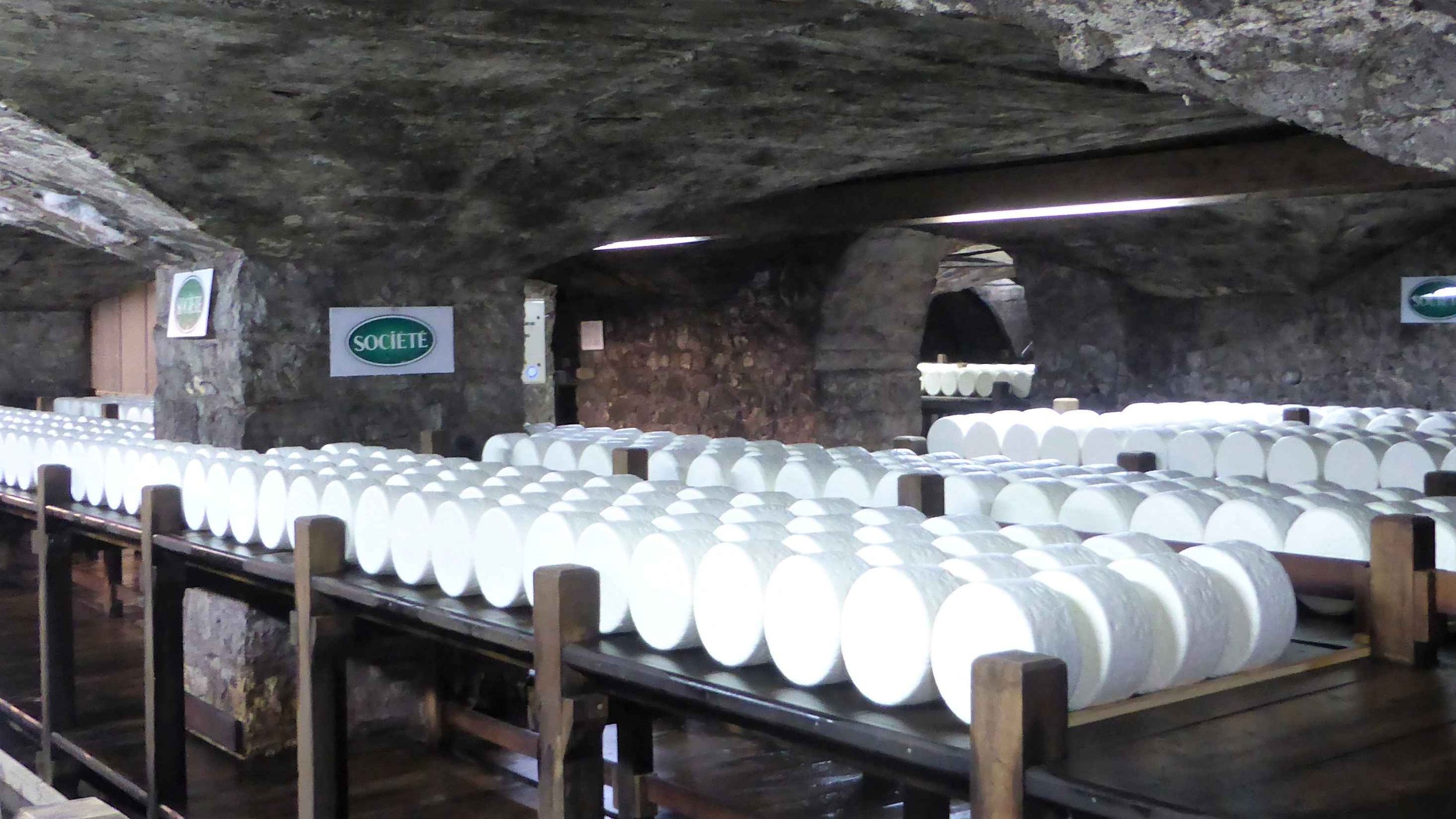 View inside the cellars of Société Roquefort (all the cheeses in this photo are display models made of resin).