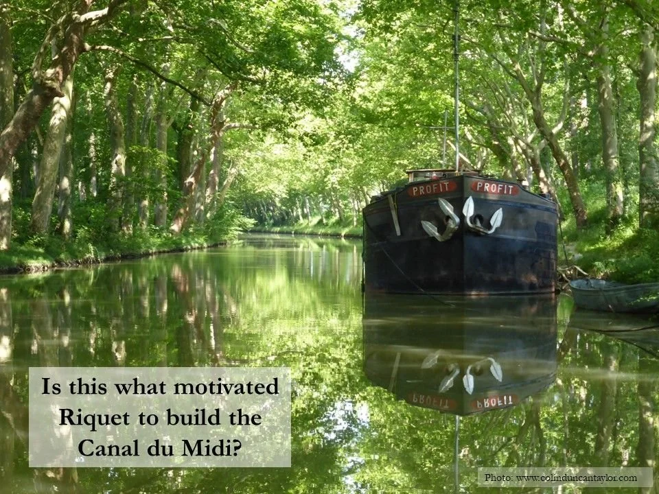 A barge called 'Profit' floats on the Canal du Midi.