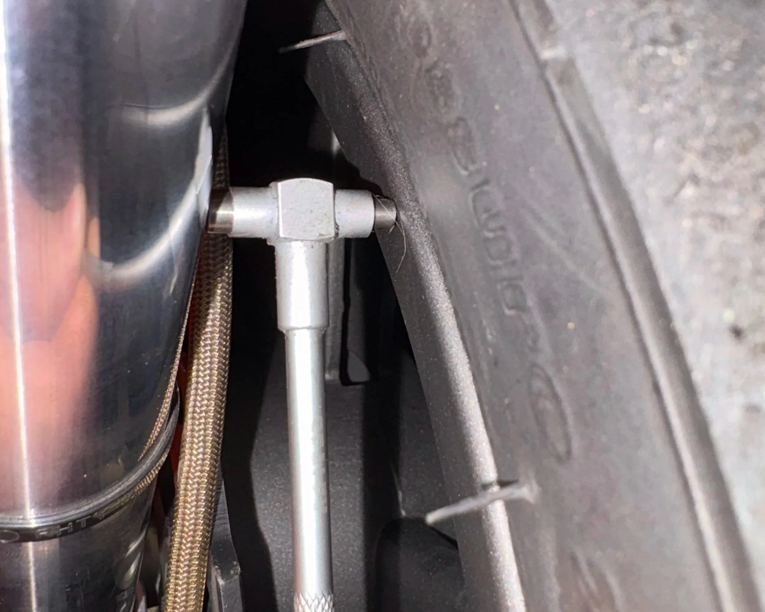 Checking motorcycle front wheel alignment using a precision depth gauge before manufacturing custom wheel spacers