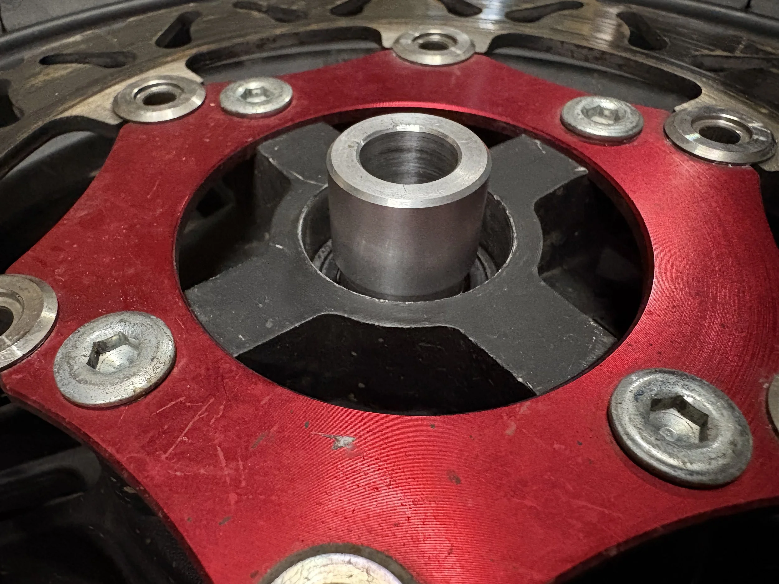 Close-up of a captive wheel spacer fitted to a supermoto wheel for fast, accurate and reliable wheel installation