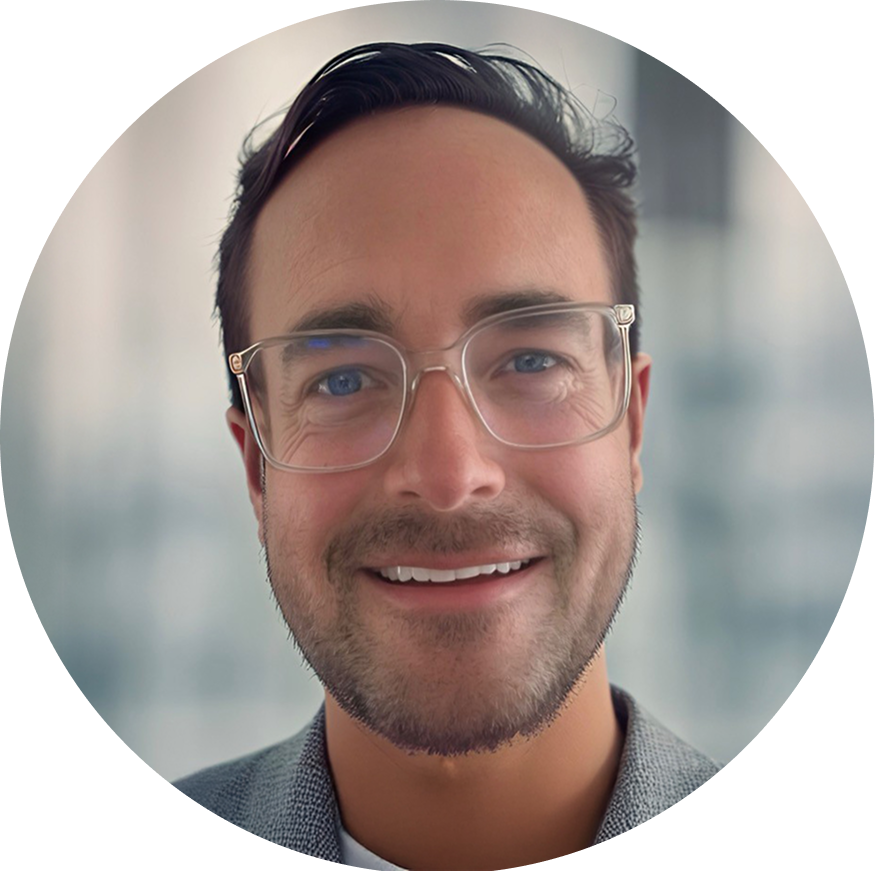 Close-up photo of our CEO, Matthew Kemp, with glasses and dark hair, wearing a suit jacket.