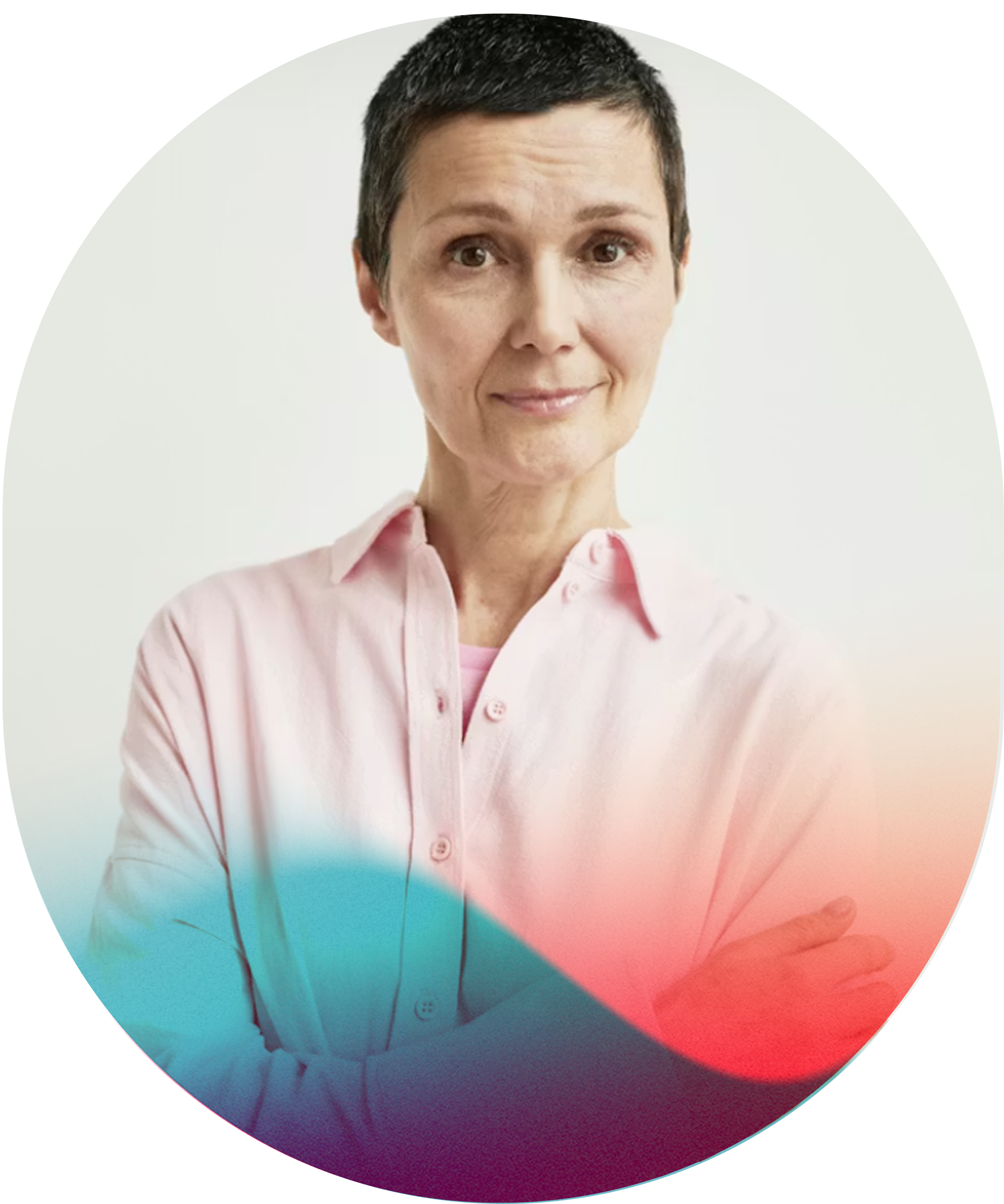 A middle-aged woman with short dark hair smiling and crossing her arms, wearing a light pink button-up shirt, against a plain white background.