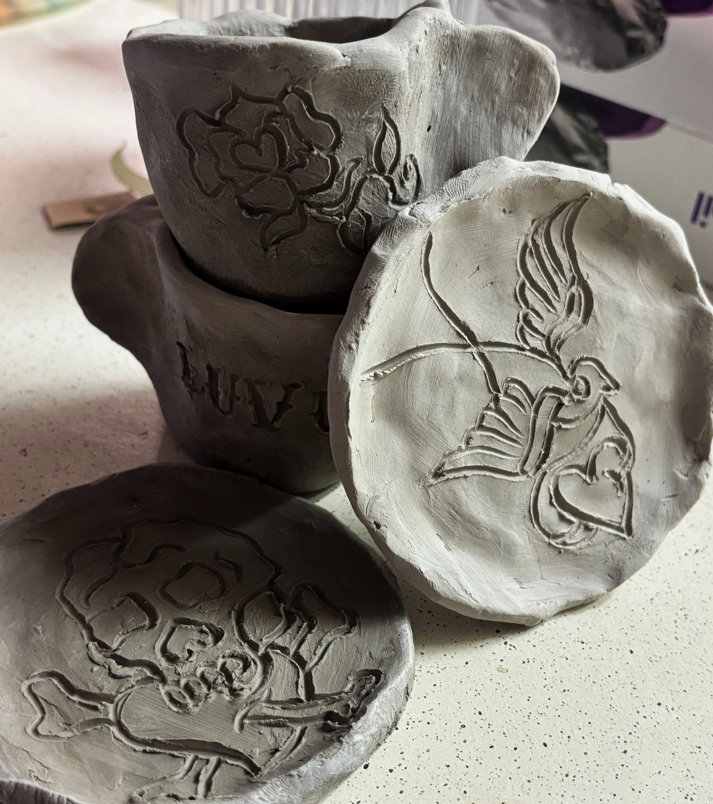 Greenware pinch-pot espresso cups and saucers. Embellished with traditional Sailor-Jerry flash designs. 