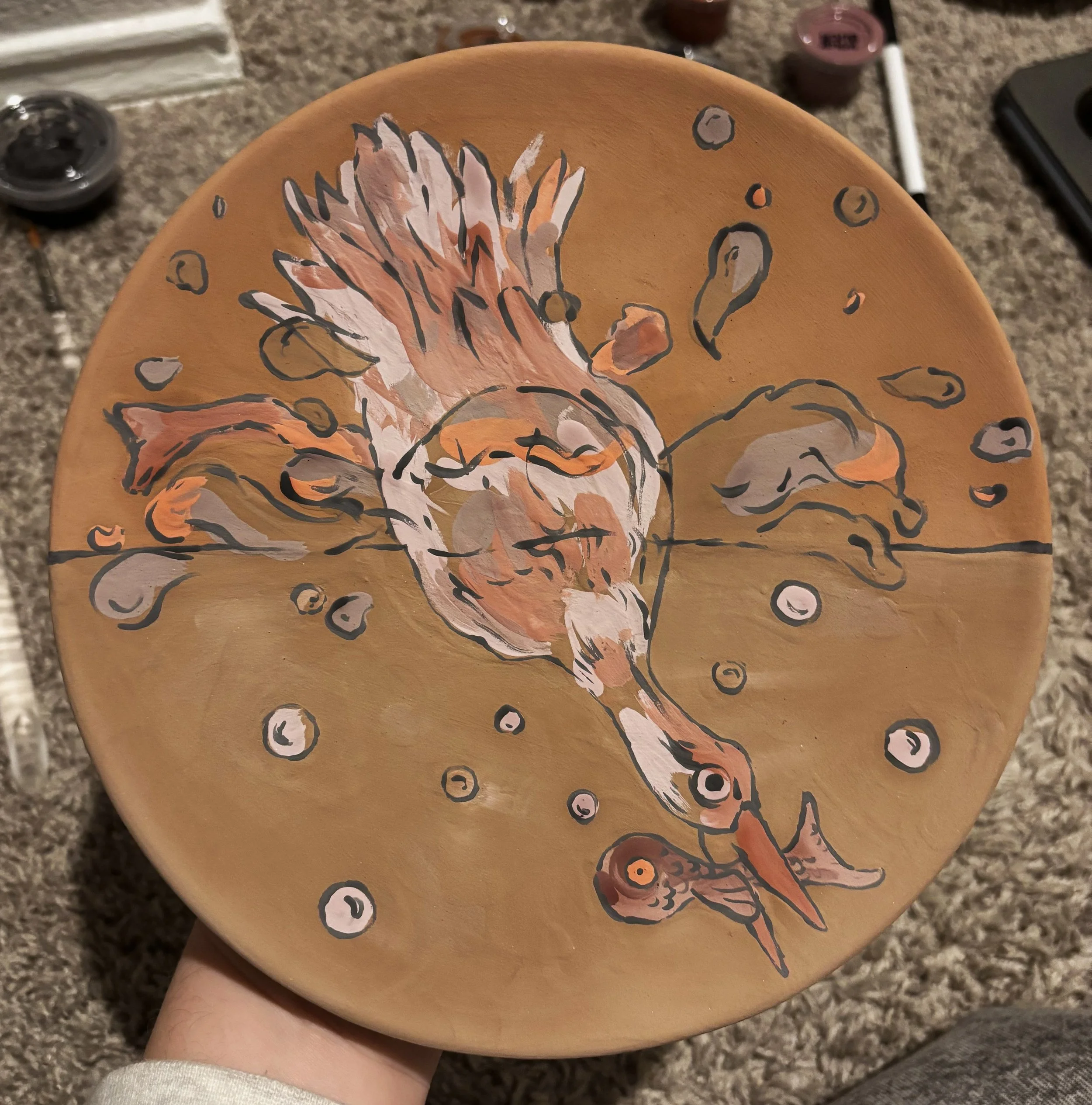 "On the Hunt", unfired, 2 of 3. This series of plates use reactive glazes that drastically change color in the kiln. This was my first time experimenting with layering such unpredictable colors. 