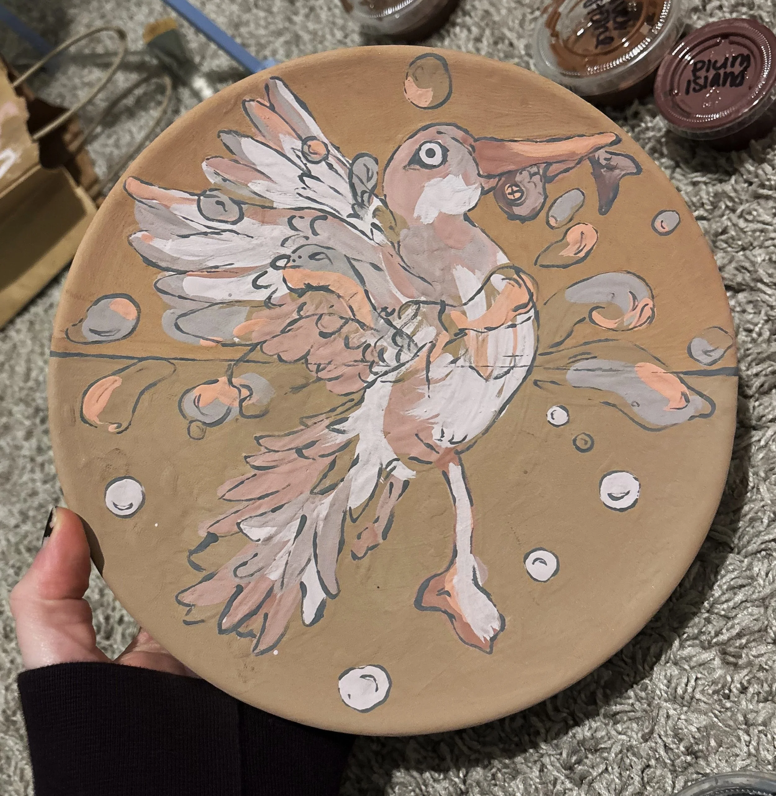 "On the Hunt", unfired, 3 of 3. This series of plates use reactive glazes that drastically change color in the kiln. This was my first time experimenting with layering such unpredictable colors. 