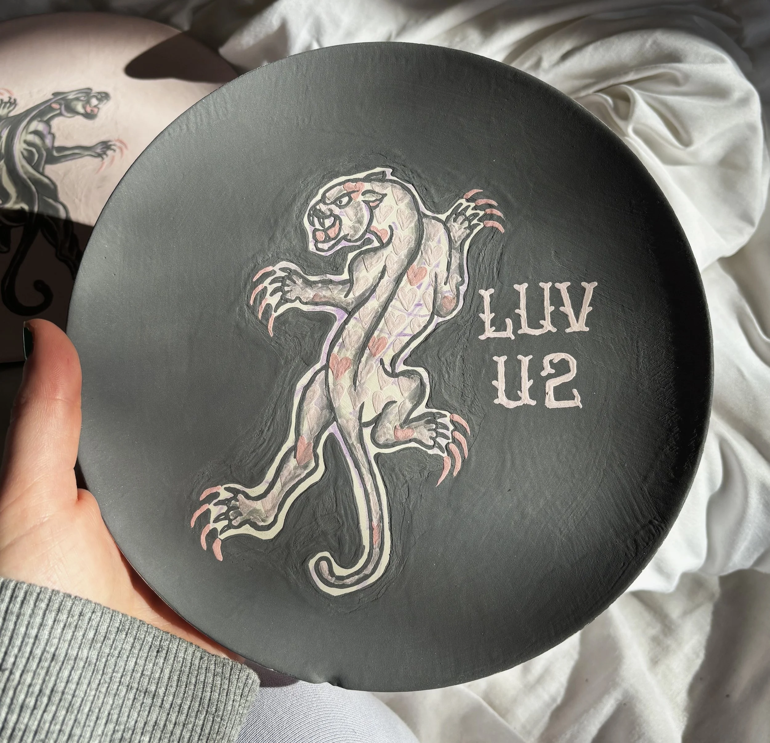 "Kitty-Gram" unfired, 1 of 2 - a Valentine's plate inspired by American traditional tattoo imagery, and candy hearts. 