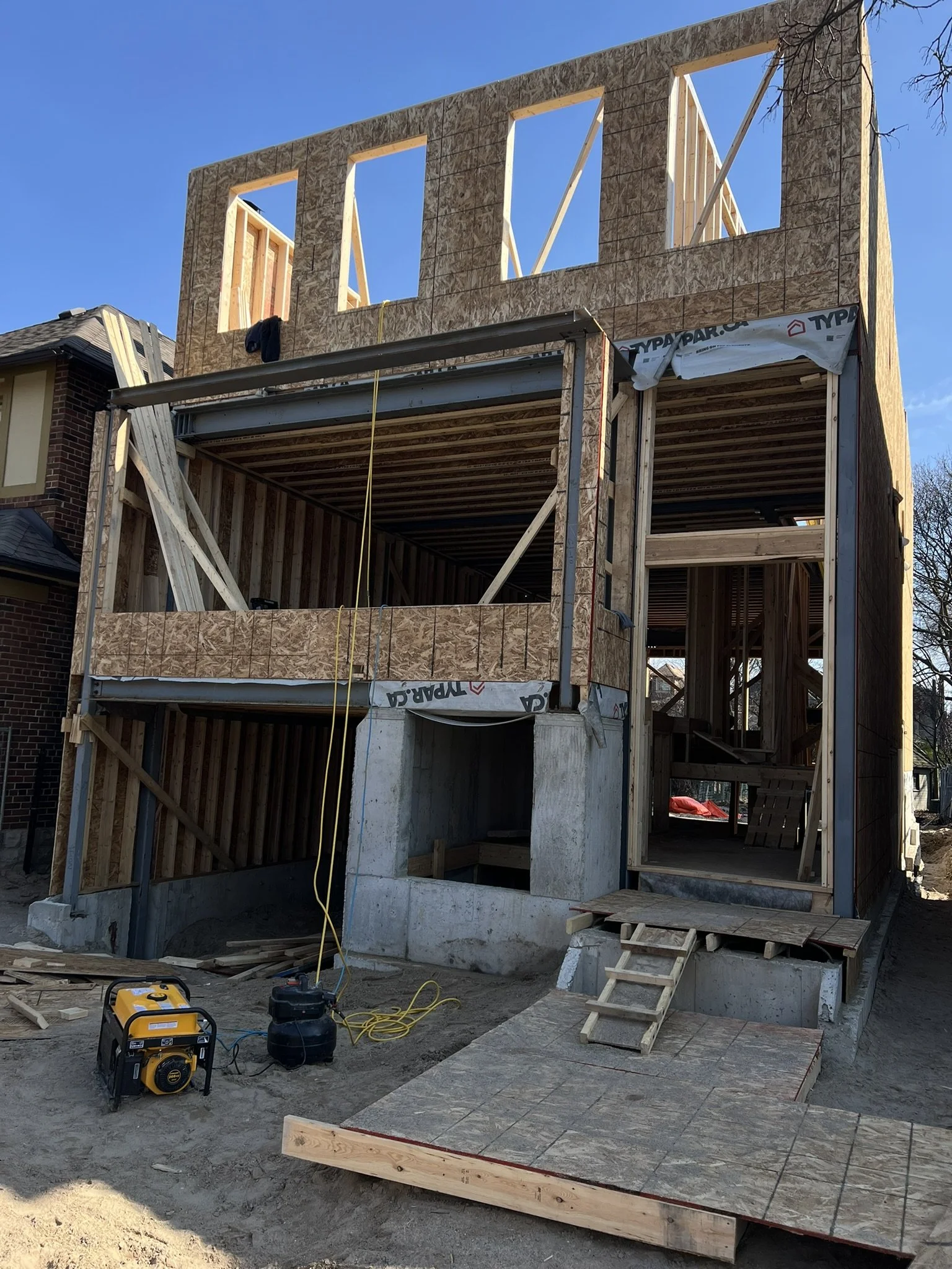 Front view of 3-storey Multiplex with integrated garage under construction.