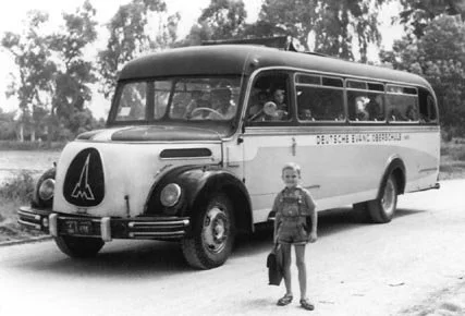 German School (DEO) bus picking up students on Road 20