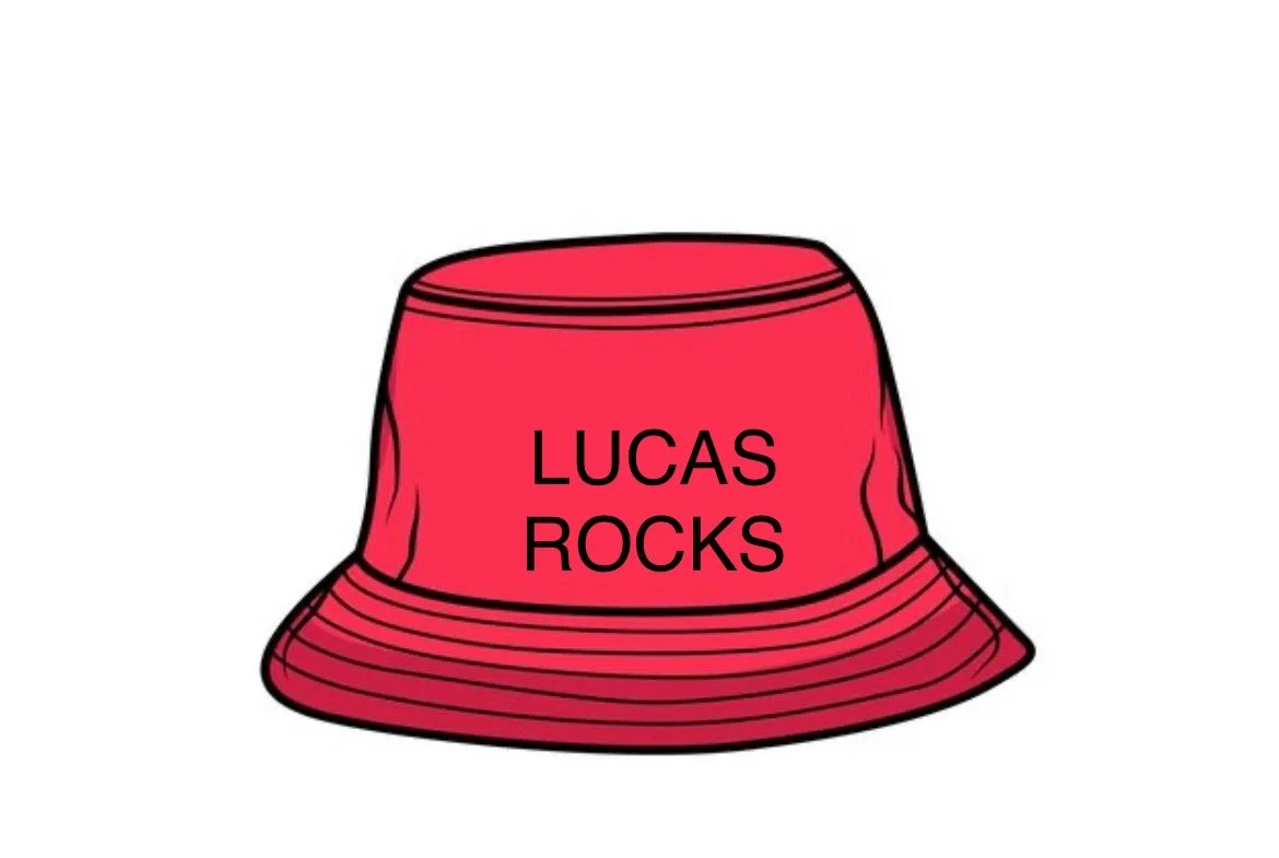 Red bucket hat with black text reading 'LUCAS ROCKS'