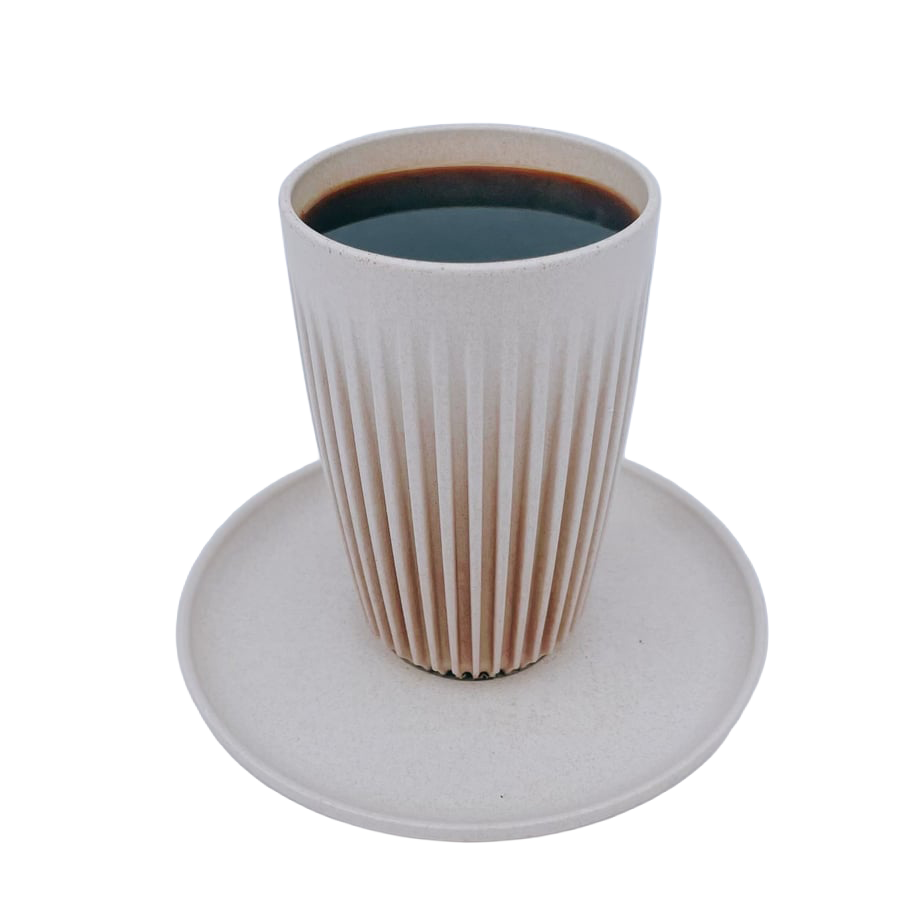 A white ceramic cup with ridges filled with black coffee, placed on a white round saucer.