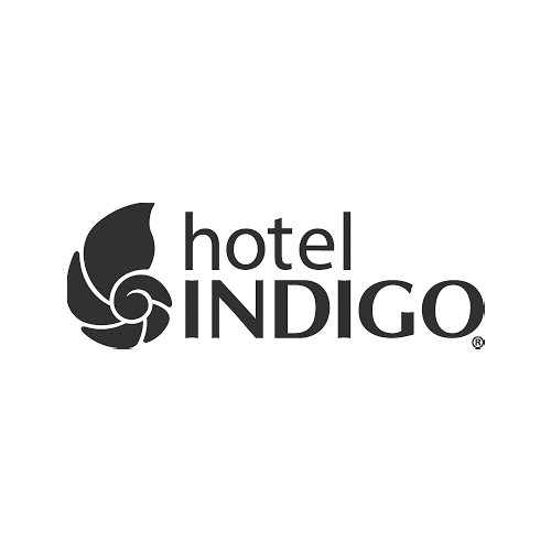 Black and white logo for Hotel Indigo featuring a seashell next to the text 'hotel INDIGO'.
