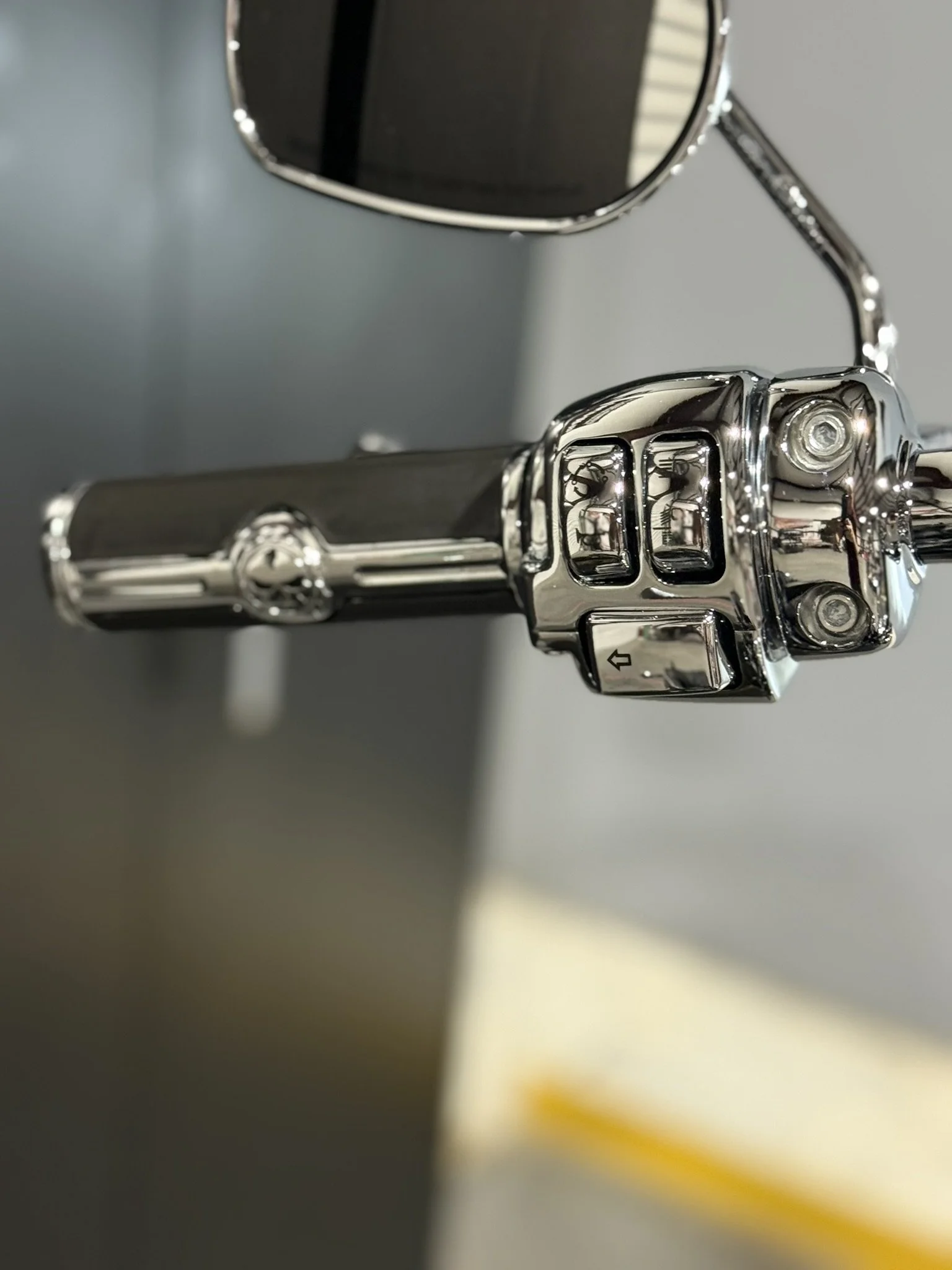 Close-up of a chrome fuel nozzle attached to a fuel pump at a gas station.