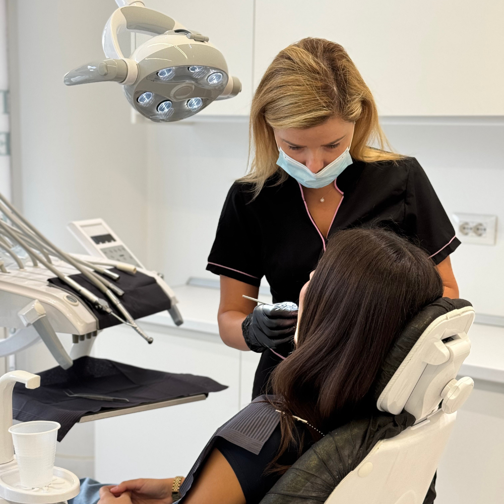 Dentist performing a dental procedure on a patient in a dental clinic.