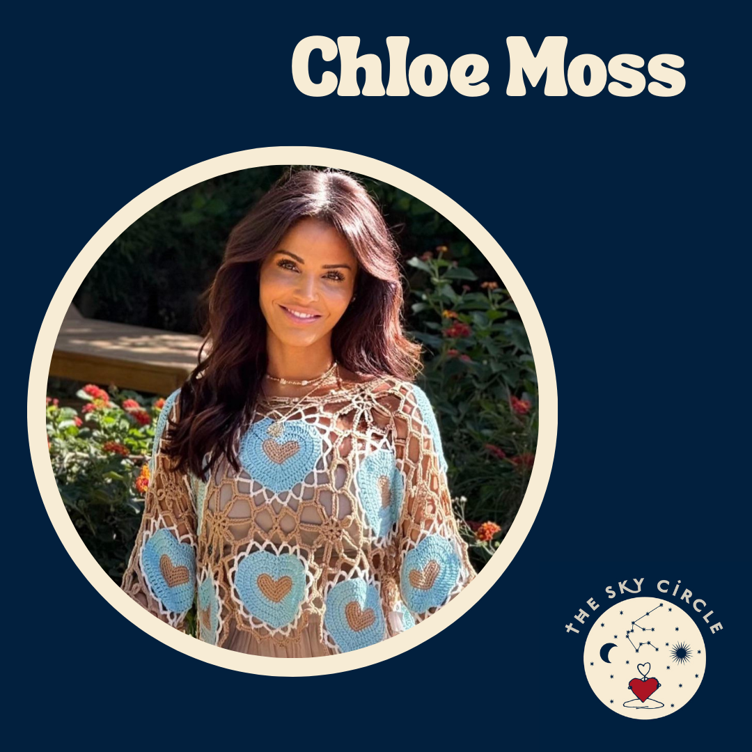 Portrait of Chloe Moss smiling outdoors with greenery and flowers in the background, wearing a crochet top with blue and brown heart designs, on a dark blue background with her name at the top and a logo of The Sky Circle in the lower right corner.