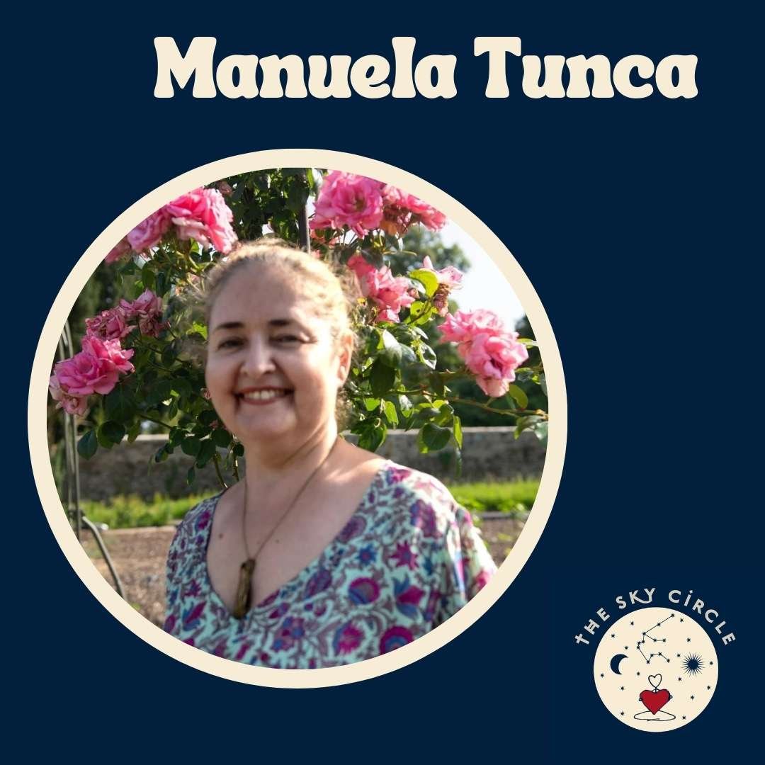 A smiling woman standing outdoors in front of pink flowering bushes, wearing a patterned top and a necklace, with a blue background and a logo in the bottom right corner.