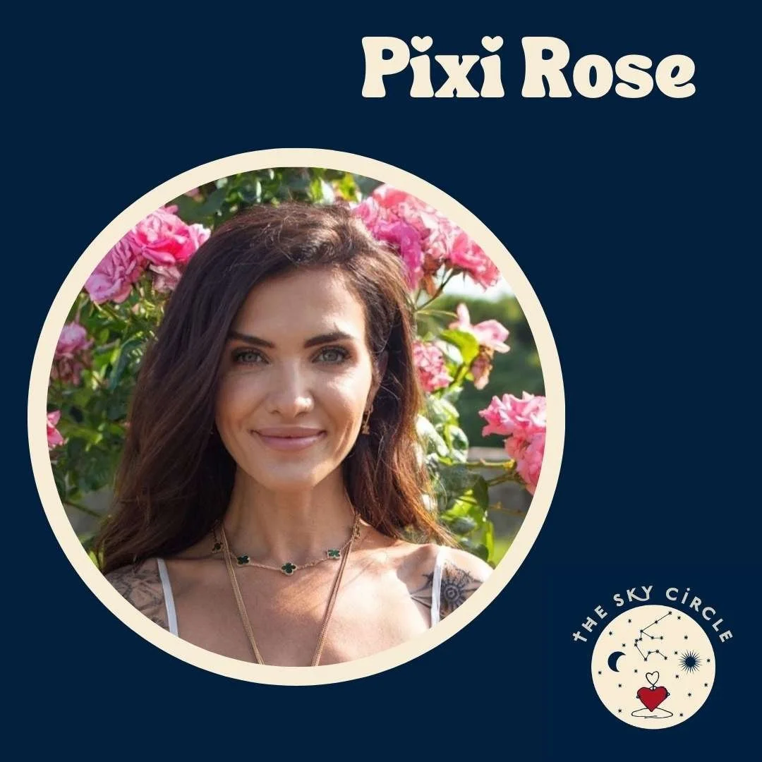 A woman with long brown hair smiling, standing outdoors in front of pink flowers, wearing a white strap top and layered necklaces, with the text 'Pixi Rose' above her and a logo with a moon, stars, and a heart below.