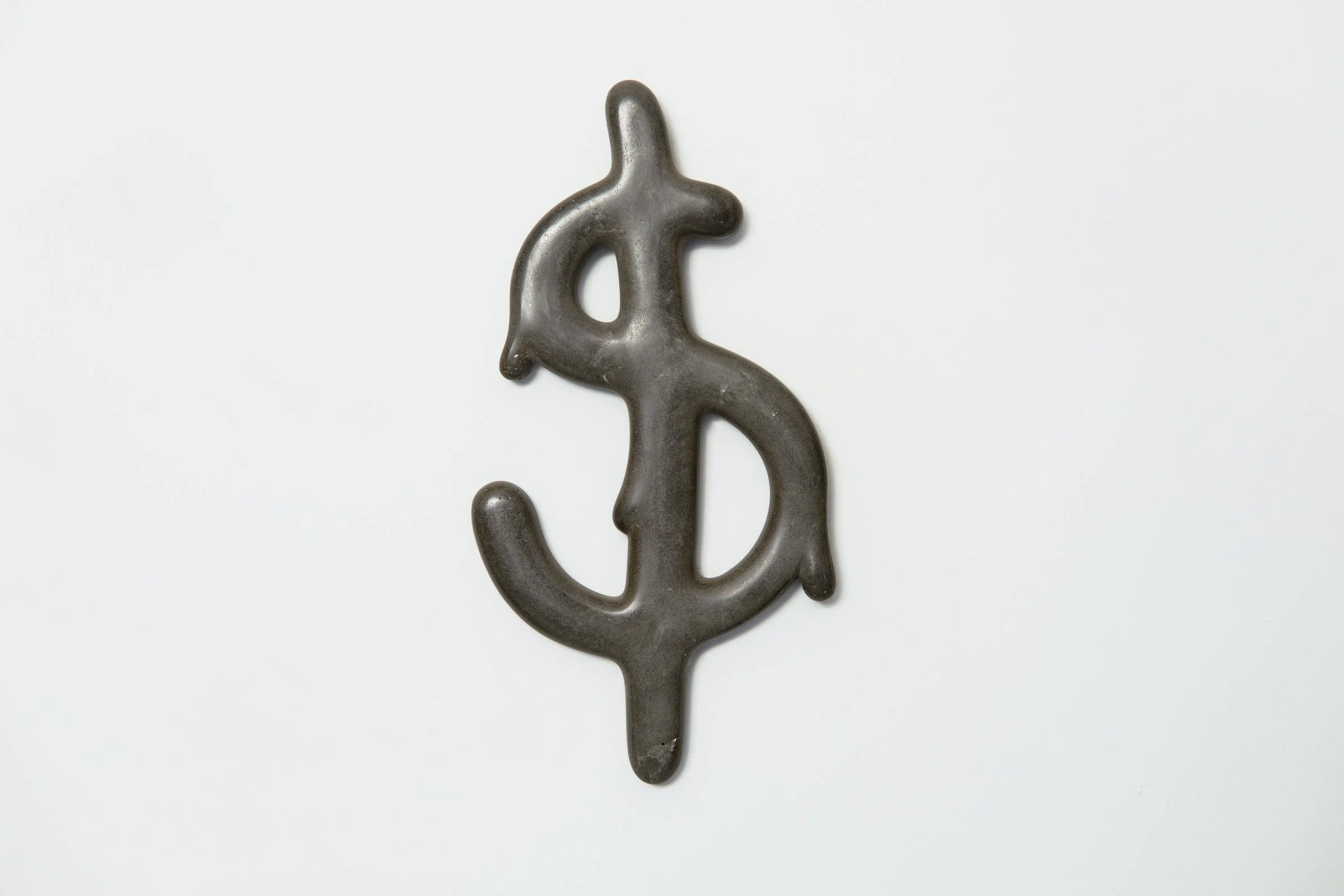 Jamie Howlett sculpture; melting dollar sign cast in dark cement and flint aggregate. Work explores dissolution of monetary iconography through lens of structural anxiety