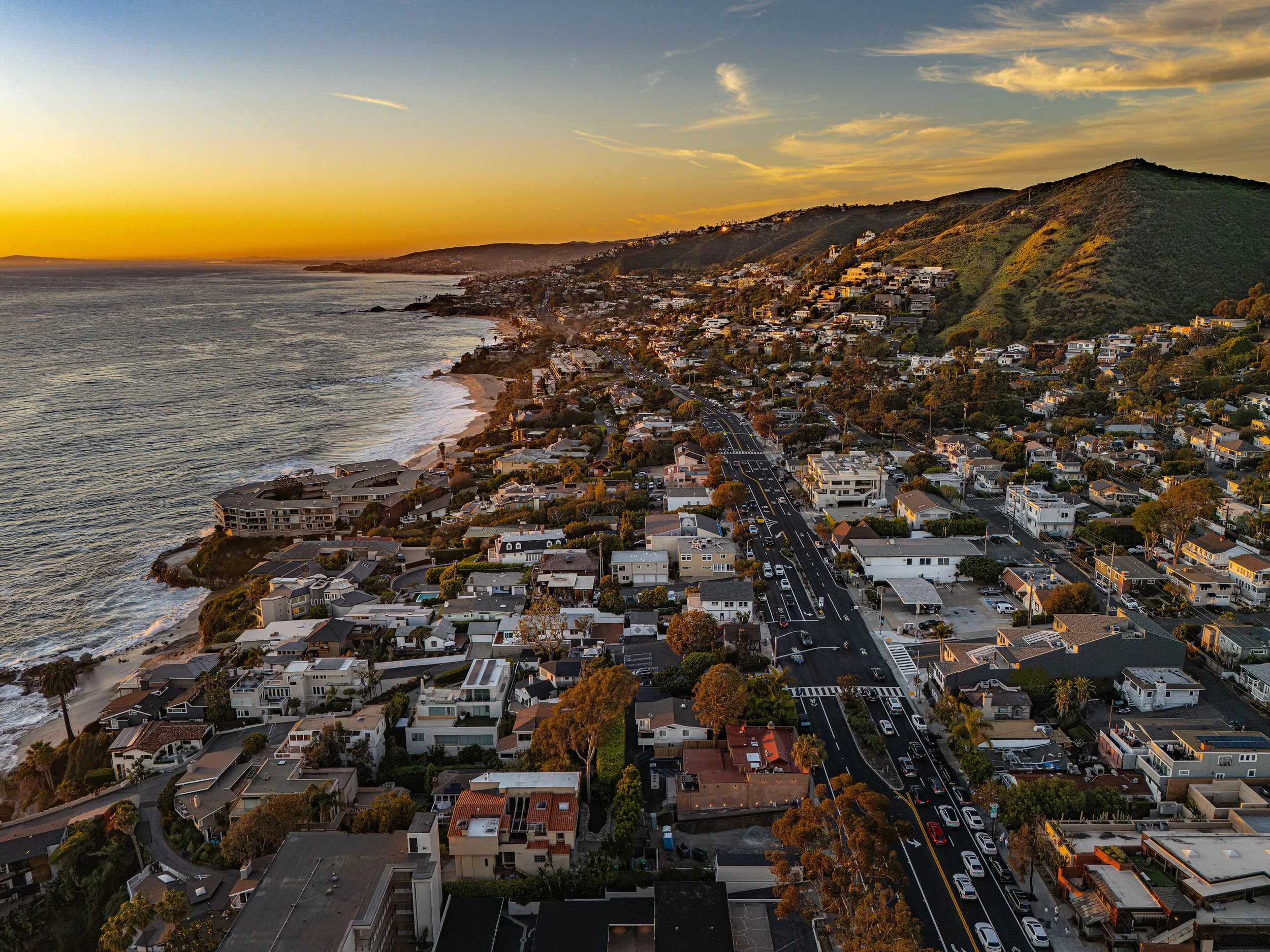 Aerial view of Laguna Beach coastline at sunset with oceanfront development