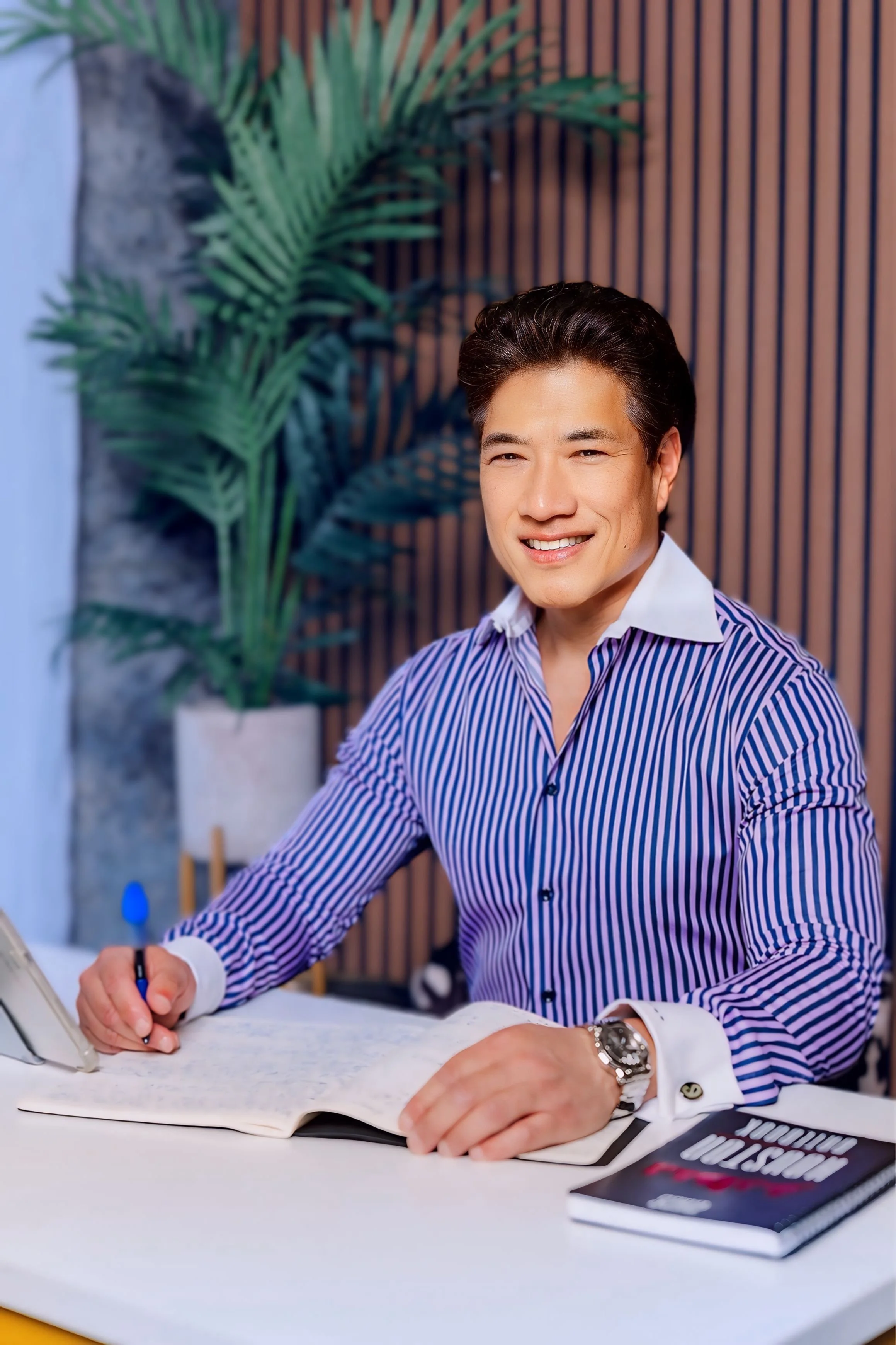 Kenneth Ro, MD sitting at desk with notebook