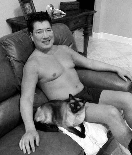 Dr. Ken Ro sitting on couch