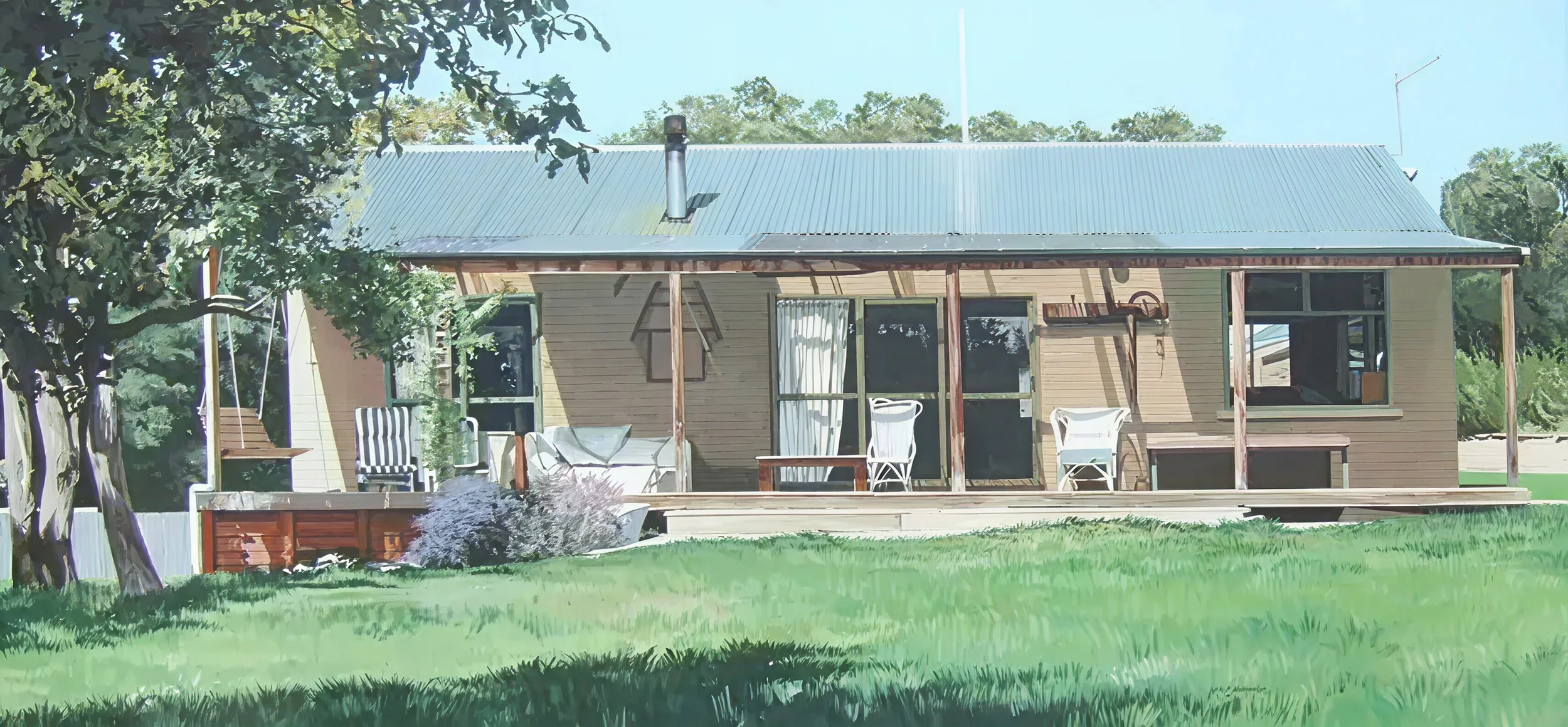 A house with a metal roof, porch, and outdoor furniture surrounded by grass and trees.