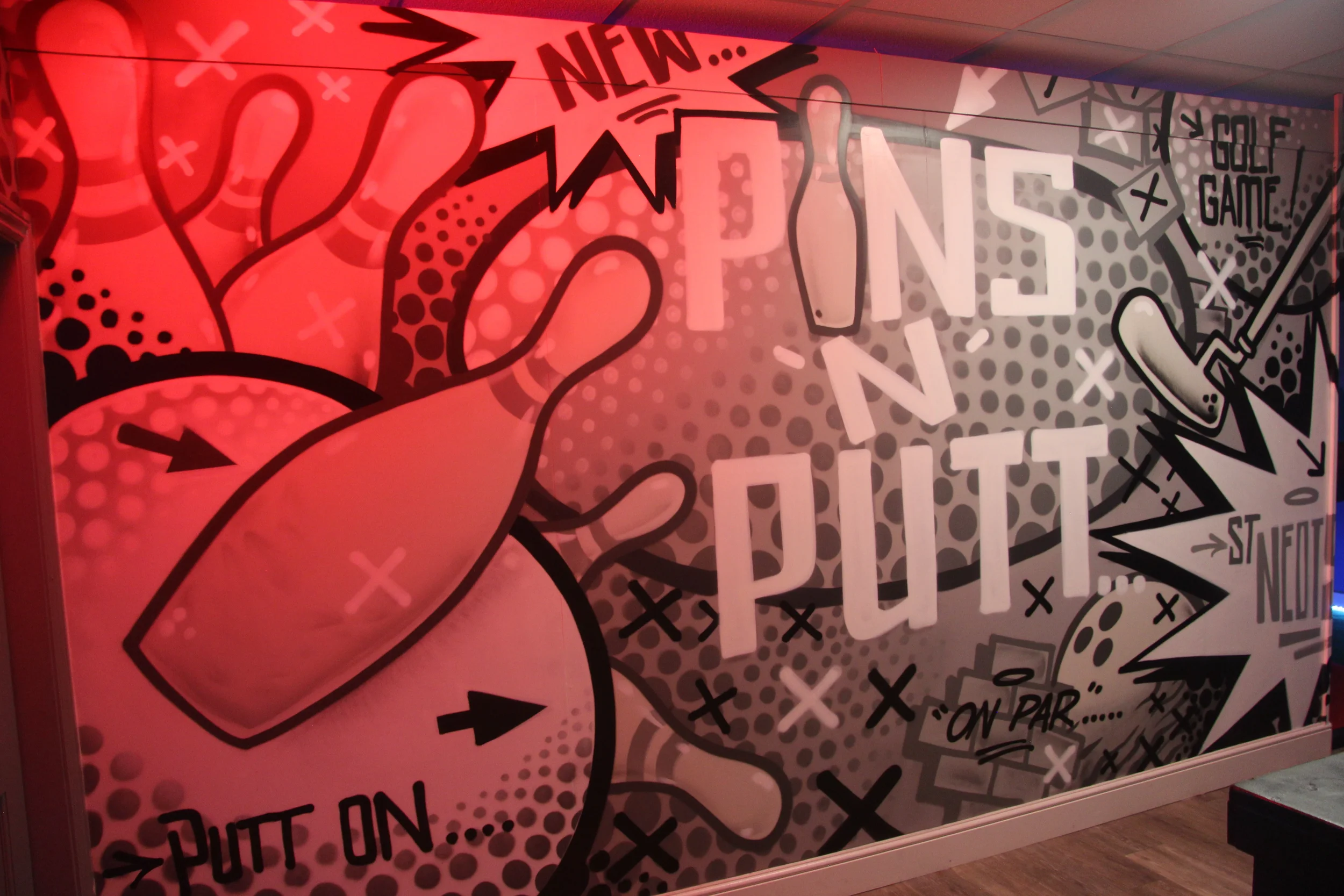 Colorful comic-style mural with sports theme, showing a baseball bat and ball, and phrases like 'PIT ON,' 'NEW,' 'ST. NOT,' and 'GOLF GAME' in various fonts and styles.