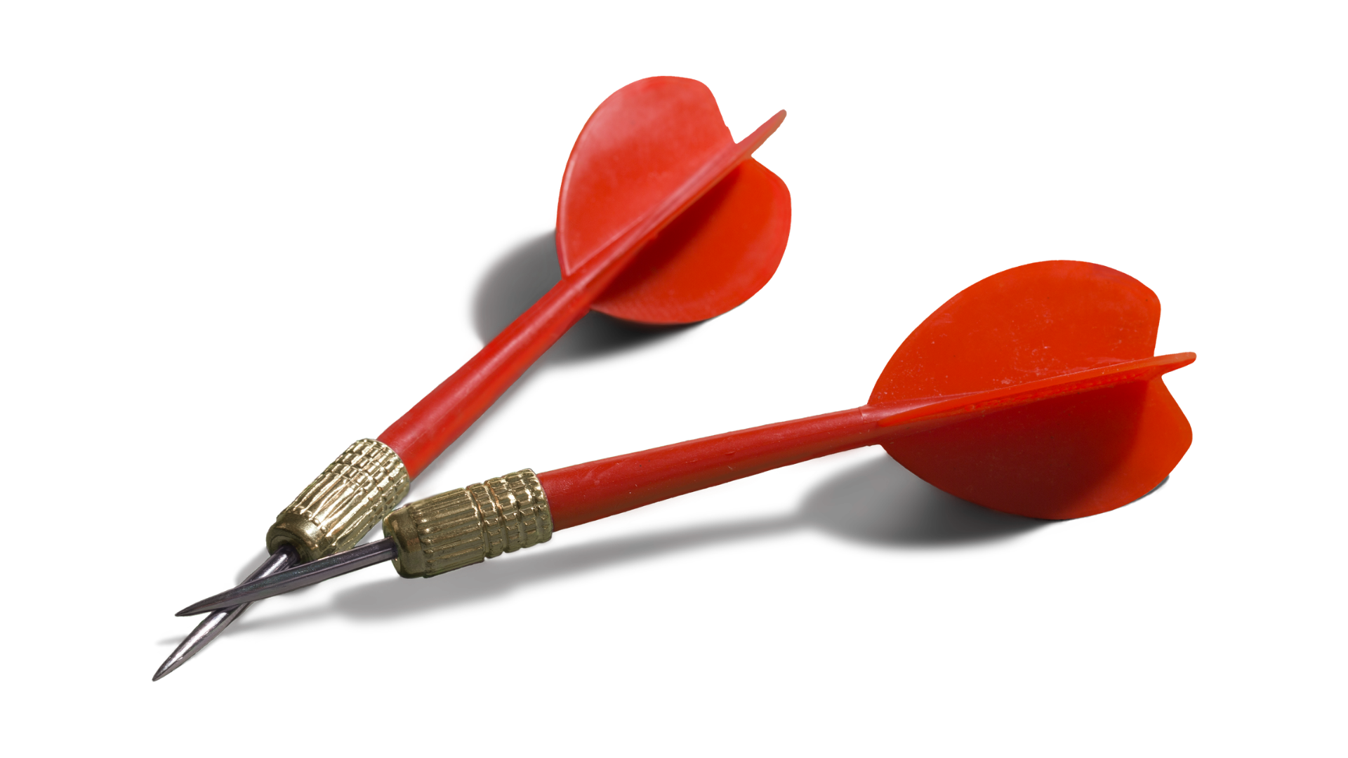 Two red darts with metallic tips and golden rings near the tips, lying on a black surface