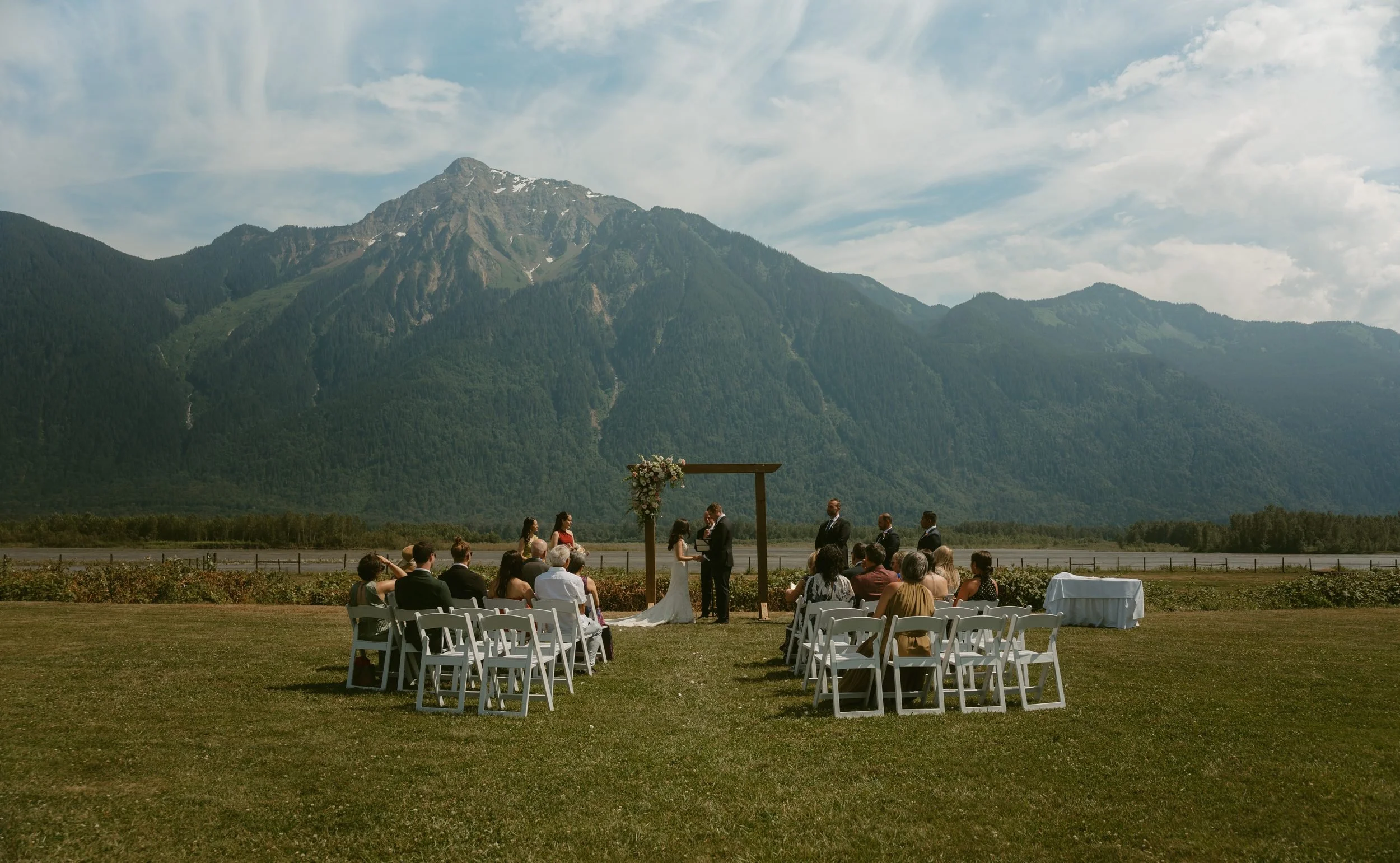 couple getting married in front of a mountain