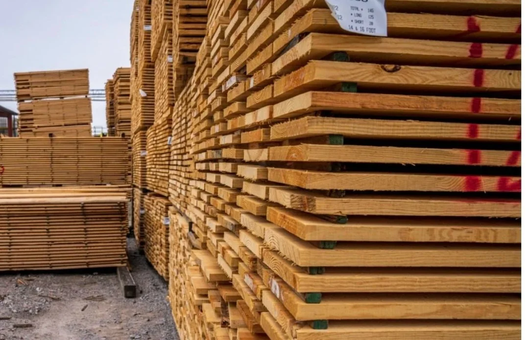 Stacks of wooden planks at a lumber yard.