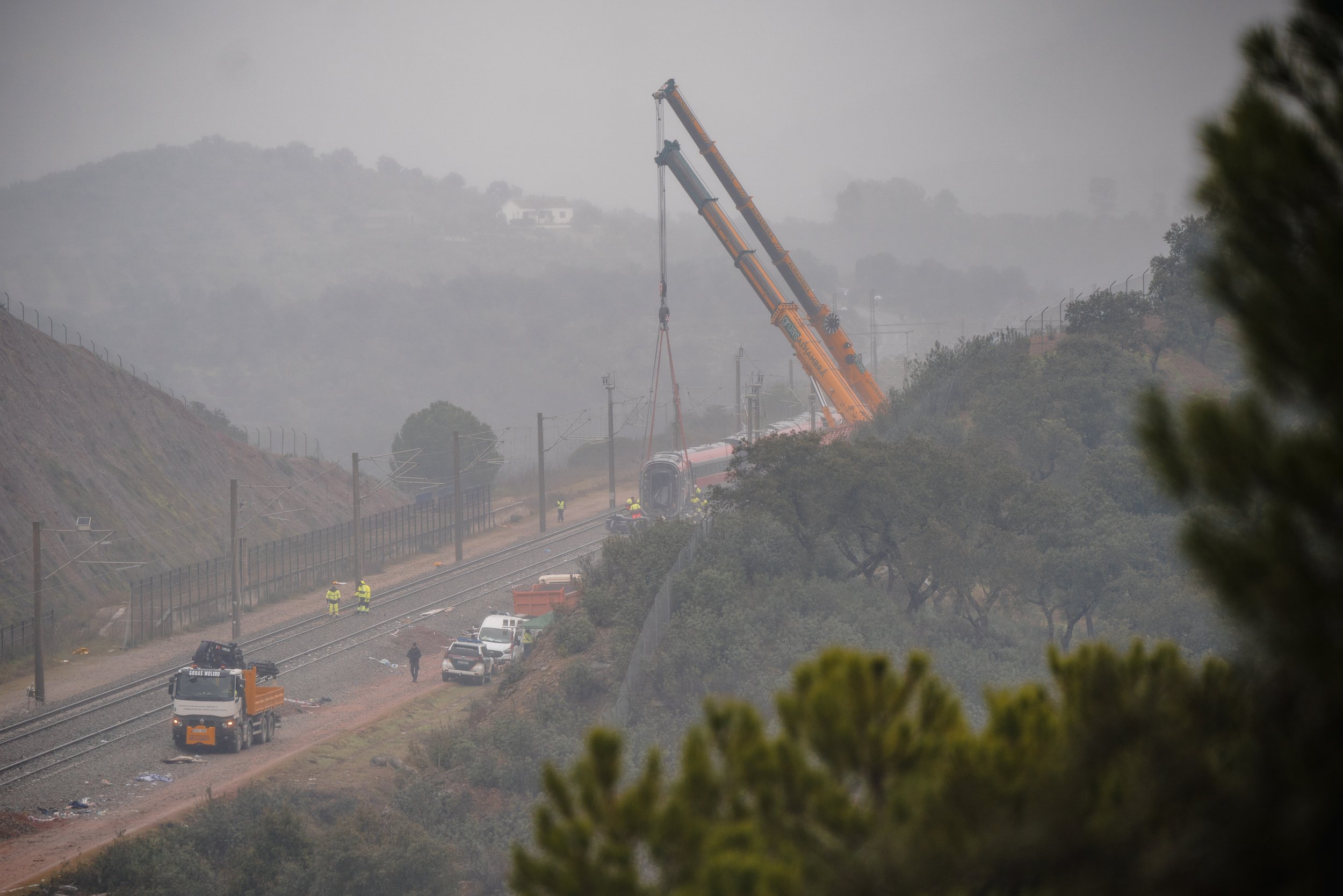 Cranes operate on the tracks to lift and remove damaged carriages of the Iryo train near Adamuz, on January 21, 2026, as cleanup and recovery efforts progressed along the high-speed line.