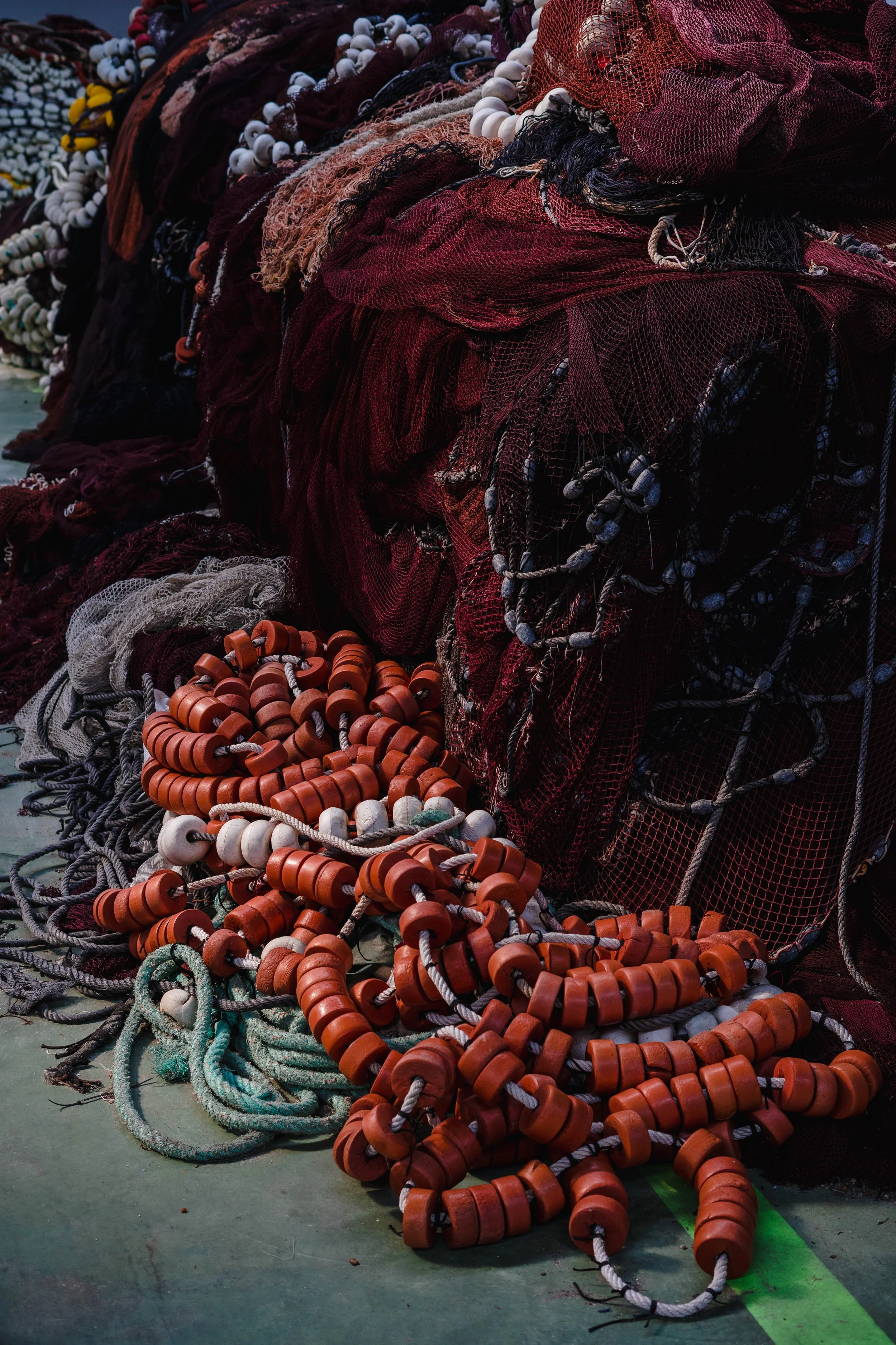 Fishing nets piled on the ground at the port of Portosín, northwestern Spain, March 2025.
