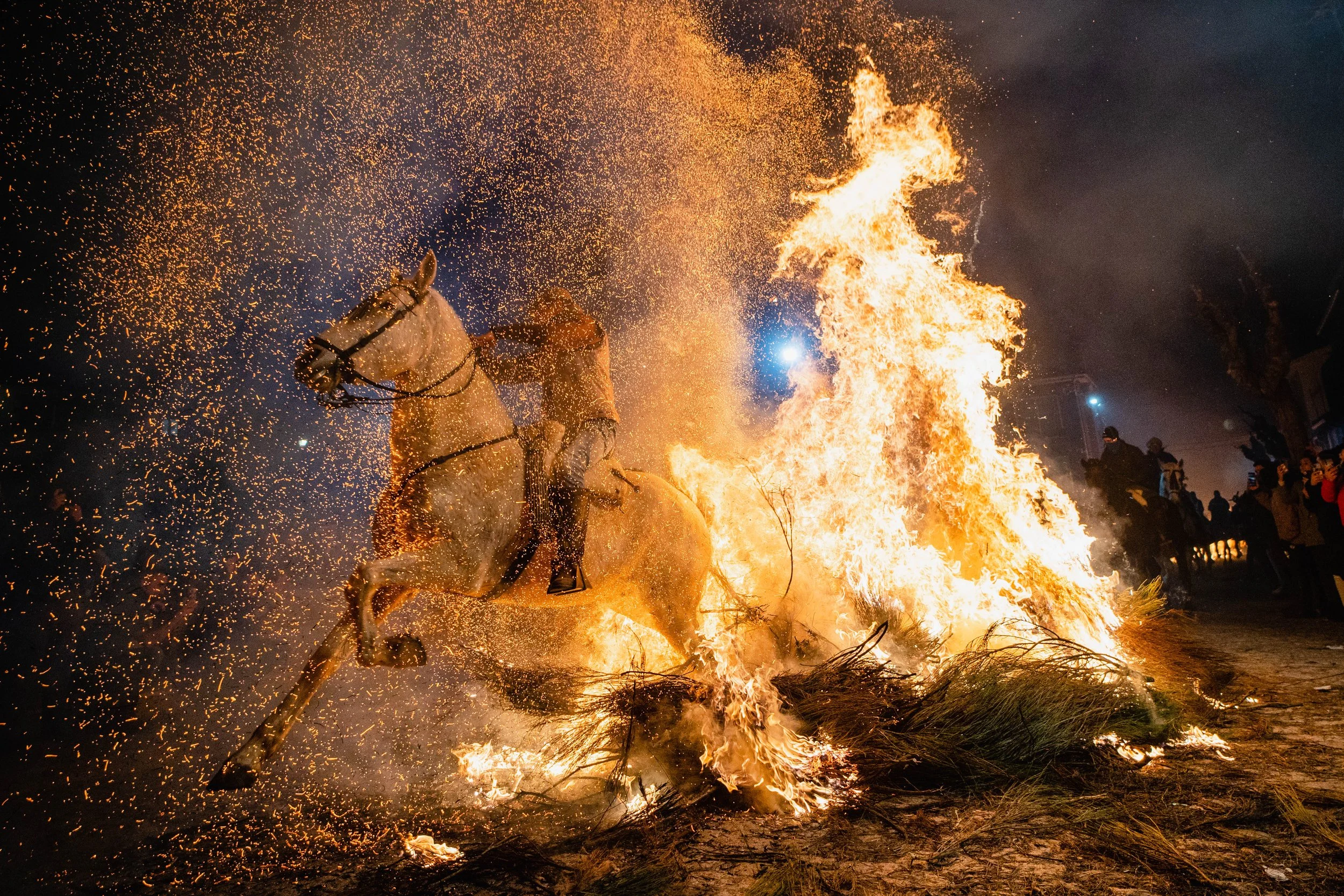 A rider and his horse pass through a bonfire prepared by residents of San Bartolomé de Pinares during celebrations on the eve of Saint Anthony Abbot, the patron saint of animals, on January 16, 2025.