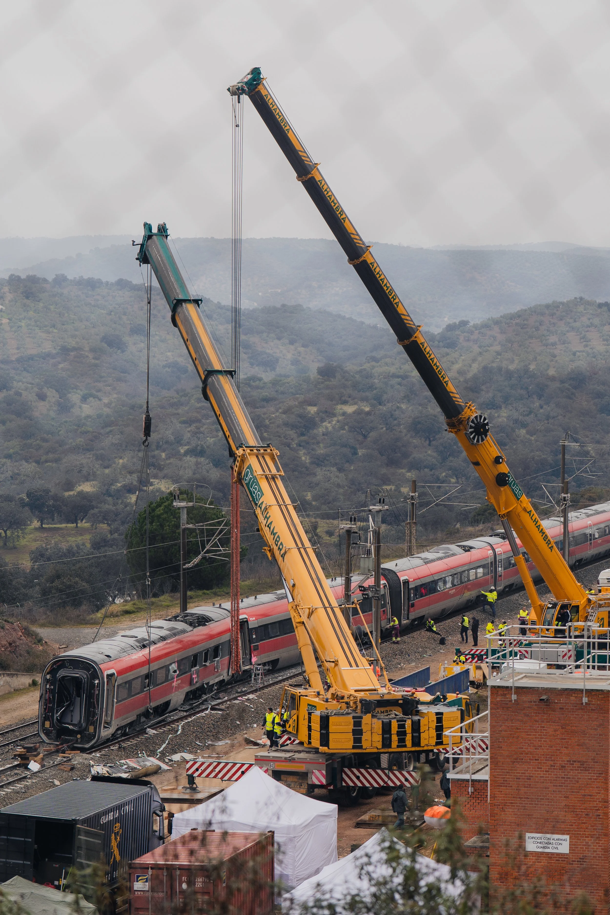 Heavy cranes operate along the high-speed line as recovery work continues on the derailed Iryo train near Adamuz, on January 21, 2026.