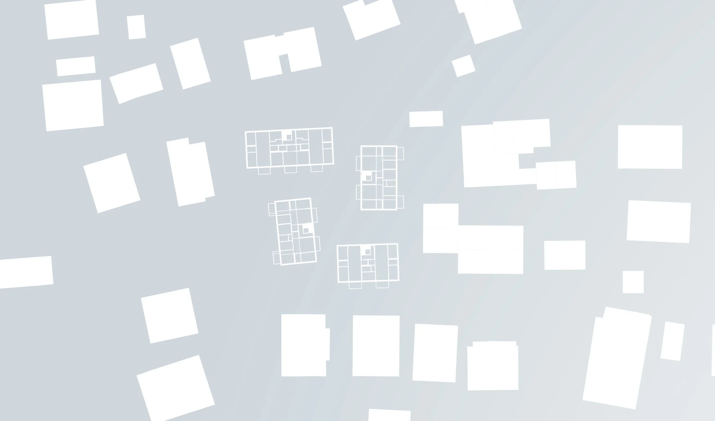 Vogelperspektive auf ein städtisches Gebiet mit weißen Bauwerken unterschiedlicher Größen auf hellem Hintergrund.