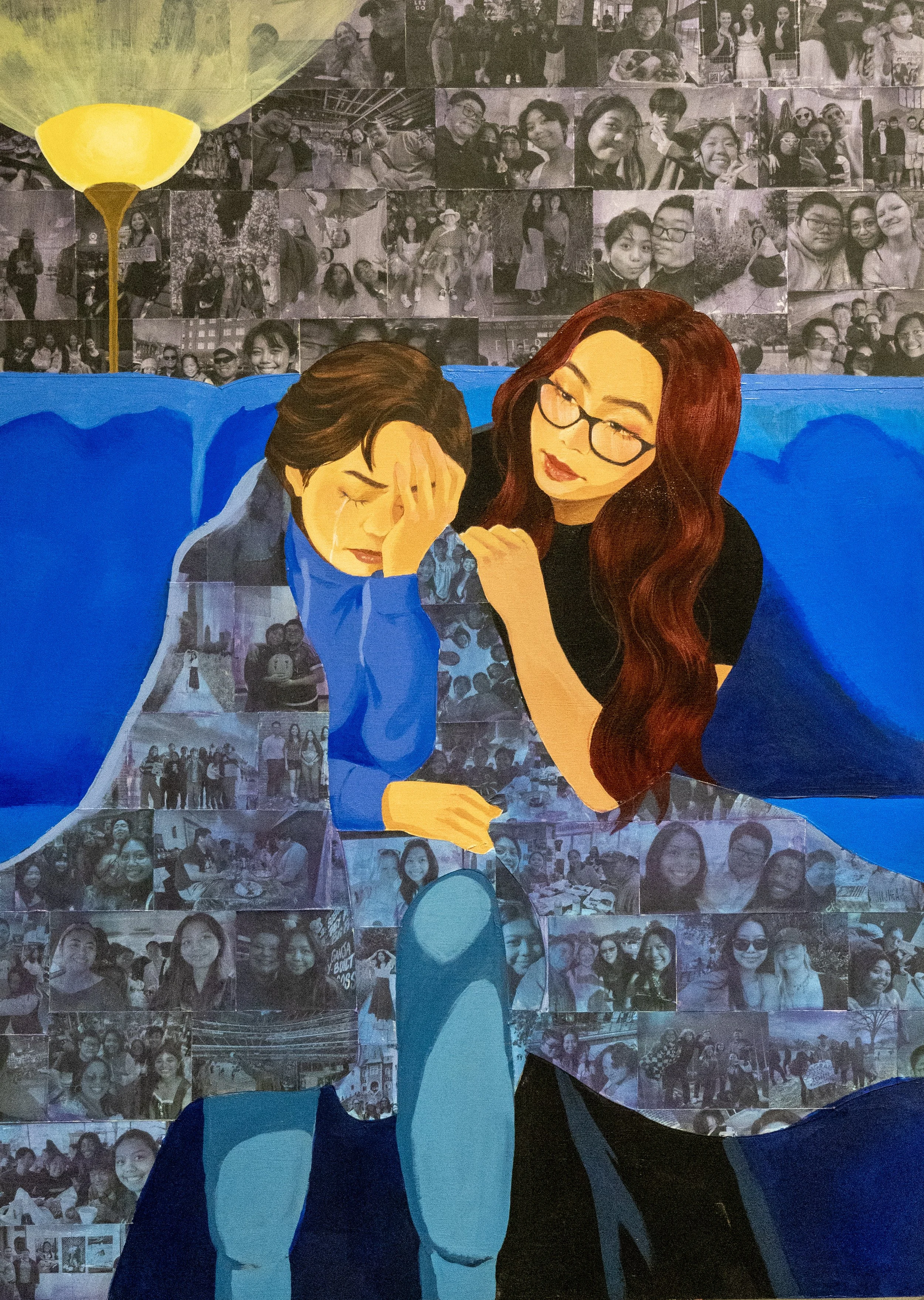 Artwork depicting a woman comforting a crying girl, with a collage of black-and-white photographs of groups of people in the background.