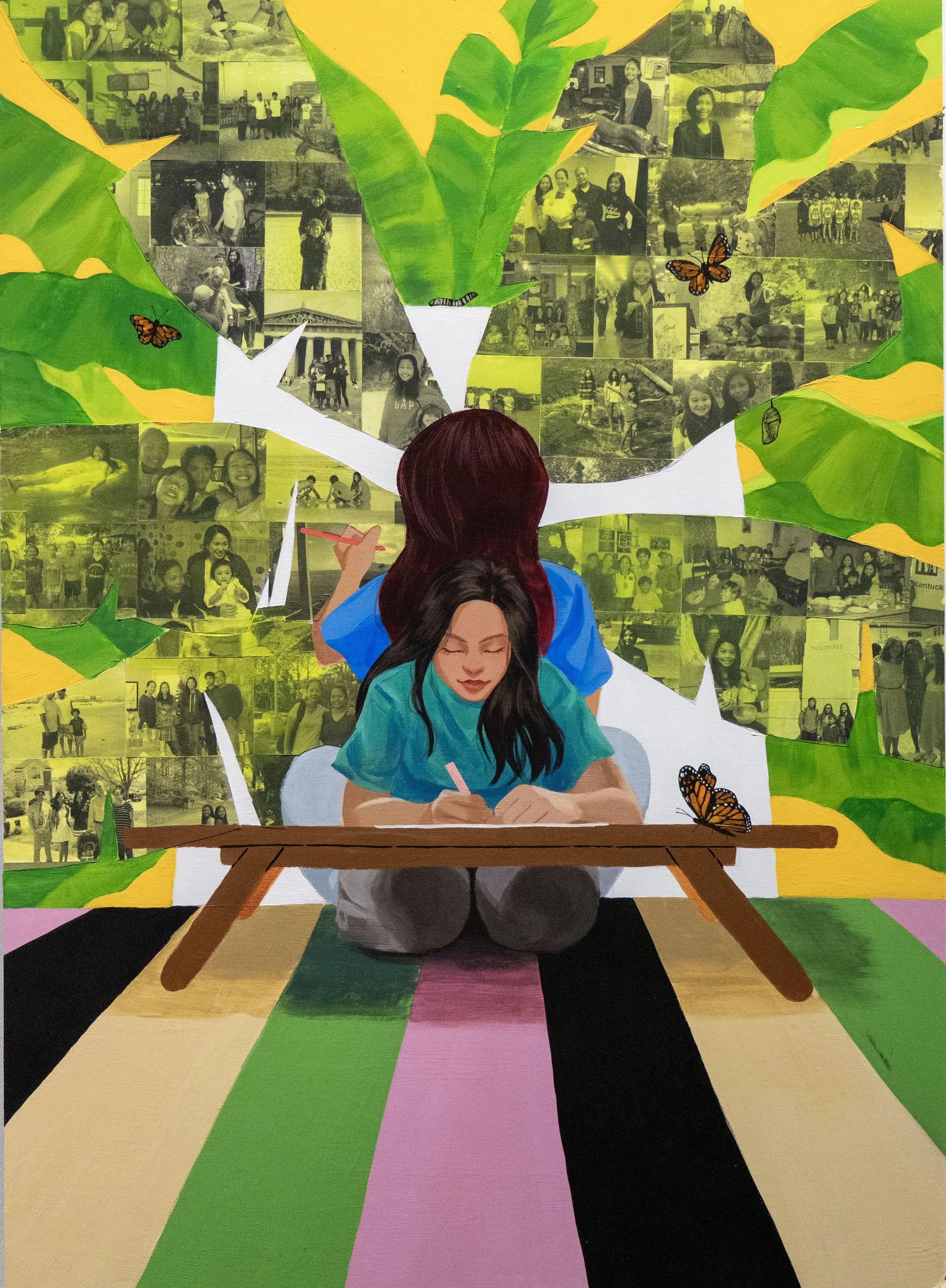 An artwork depicting two girls, one with long black hair and one with brown hair, sitting on the floor in front of a colorful mural. The girl with black hair is writing on a piece of paper, while the girl with brown hair is painting a tree with green and yellow leaves. The mural background includes numerous black and white photos and orange butterflies.