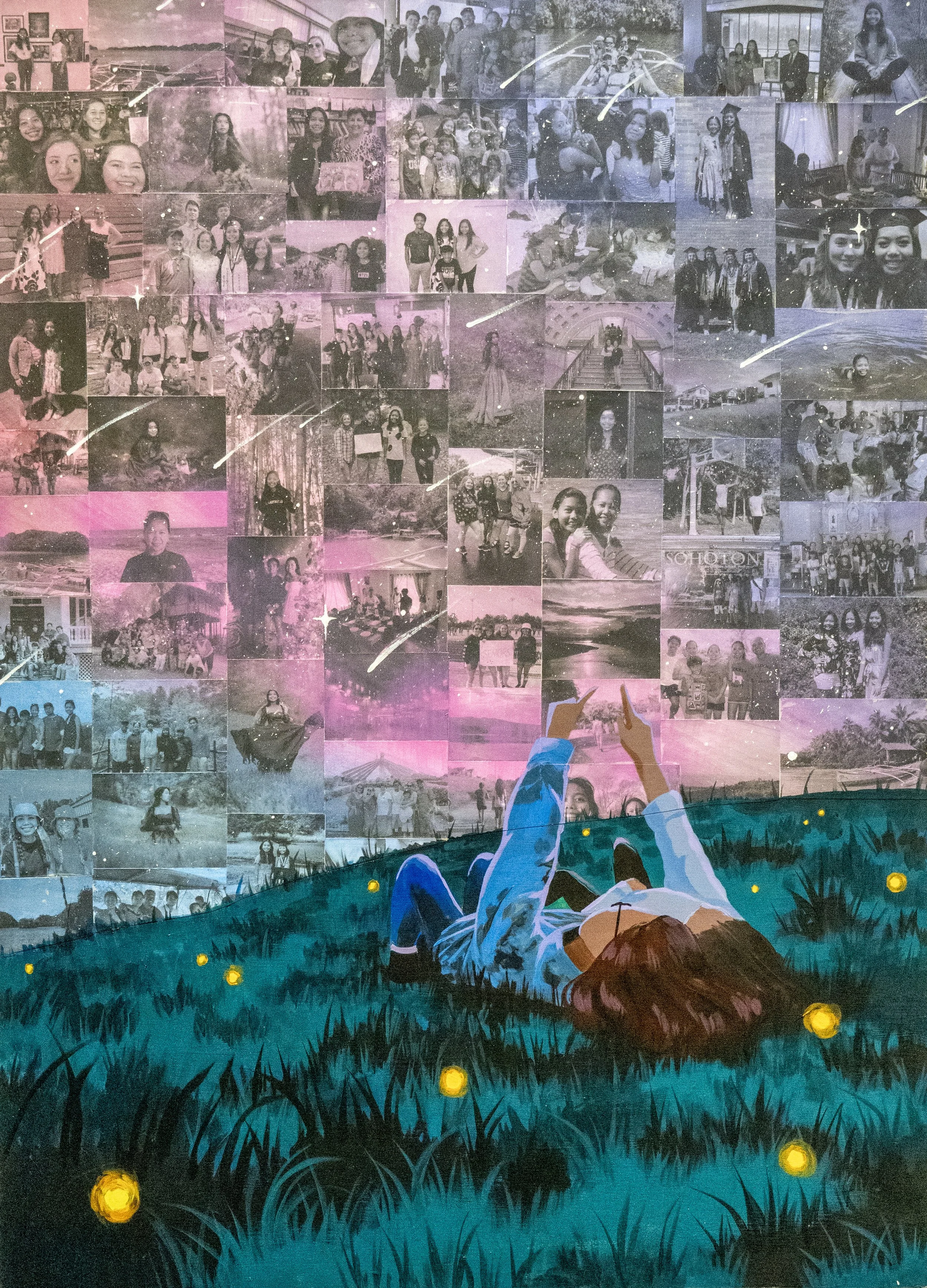 A collage of black and white photographs on a wall with people posing and groups, topped with a painted scene of a person lying in grass holding hands with a person standing. The scene includes small glowing yellow balls scattered on the grass, creating a dreamy atmosphere.