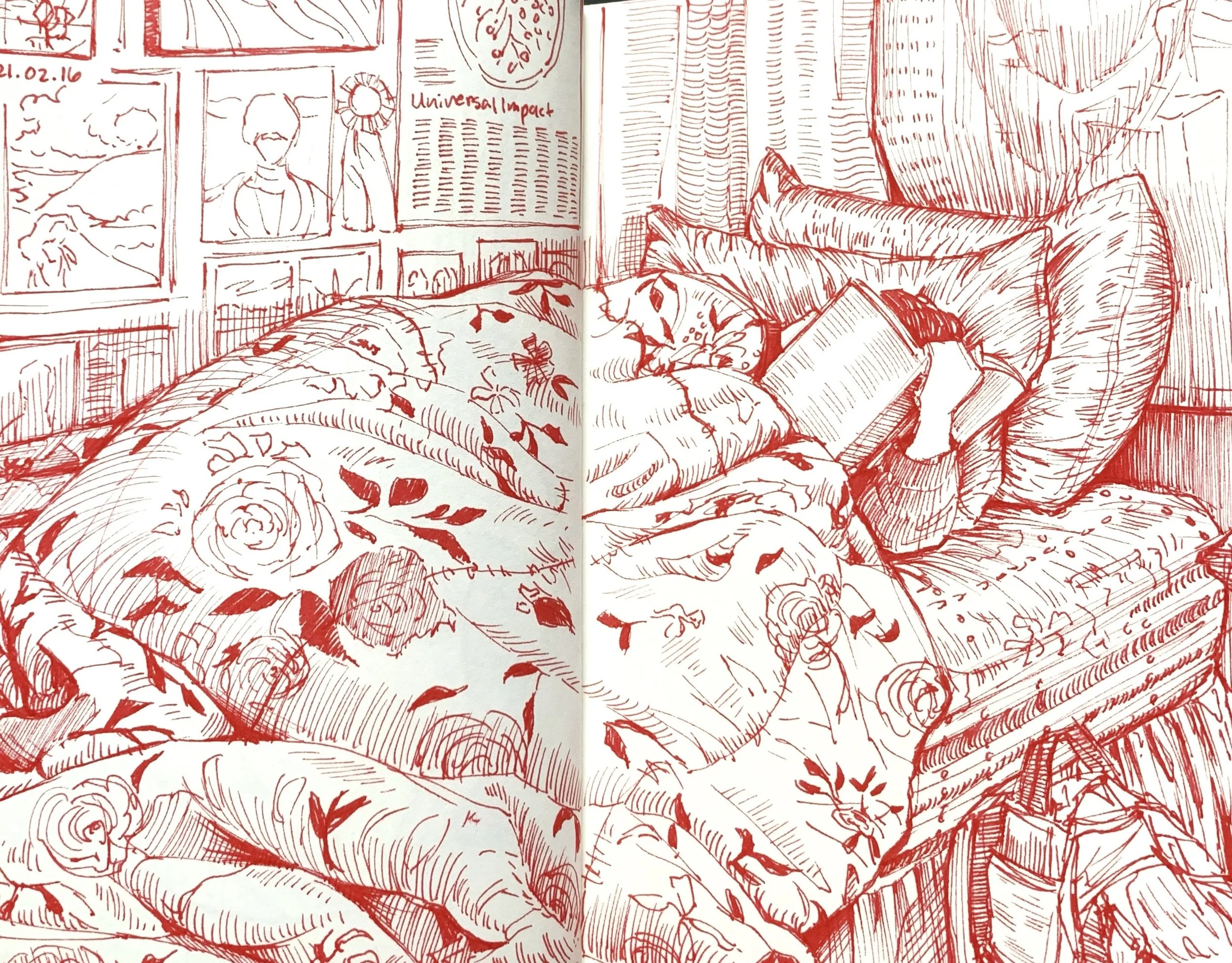 A person is sleeping on a cozy couch with floral and patterned pillows. They are holding a book, with a blanket covering part of their body. The wall behind them features a collage of framed pictures and artwork.