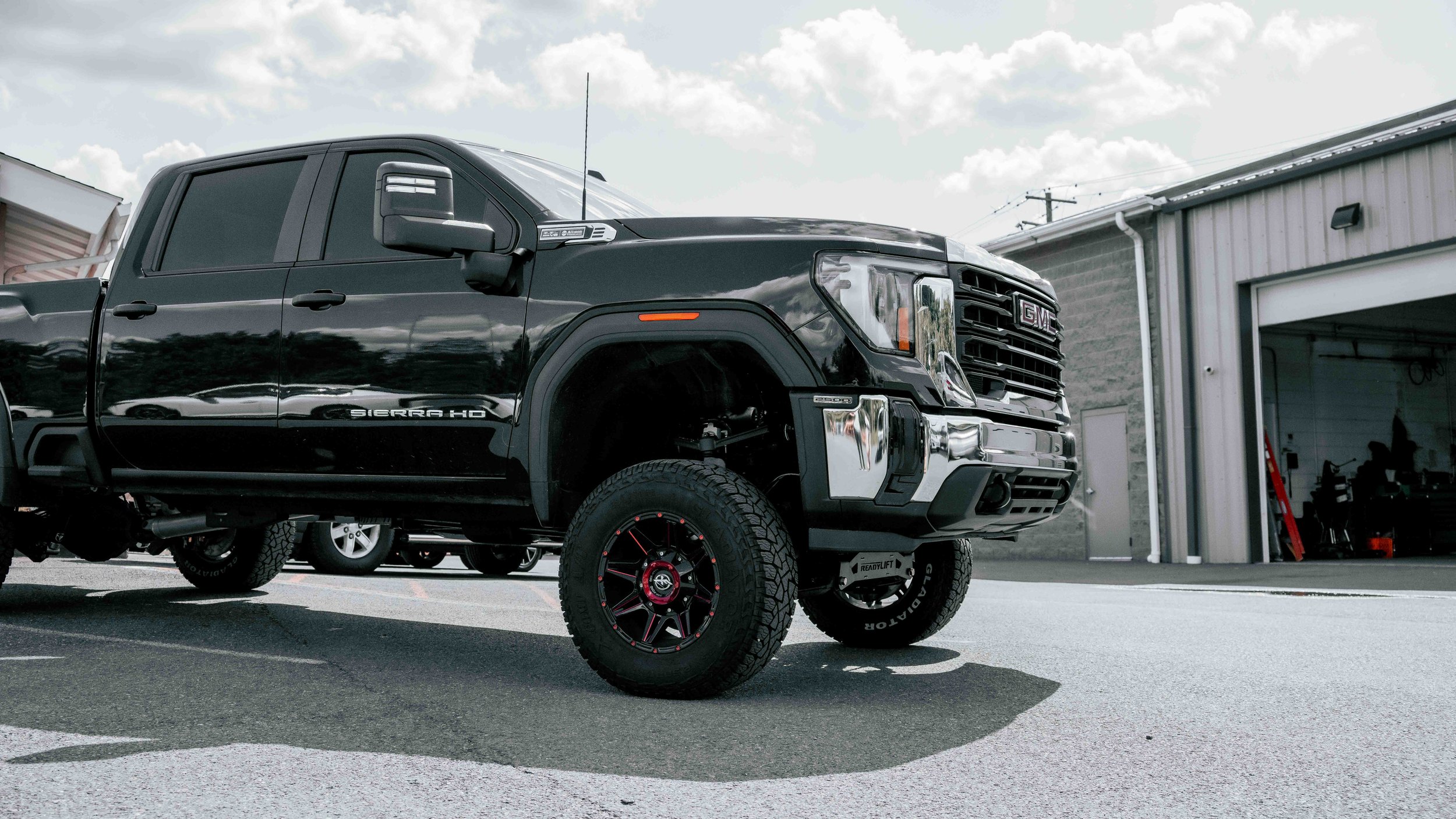 Finished lifted GMC Sierra HD with ReadyLIFT suspension and off-road wheels outside Xtreme Car & Truck in Bridgeville, PA.