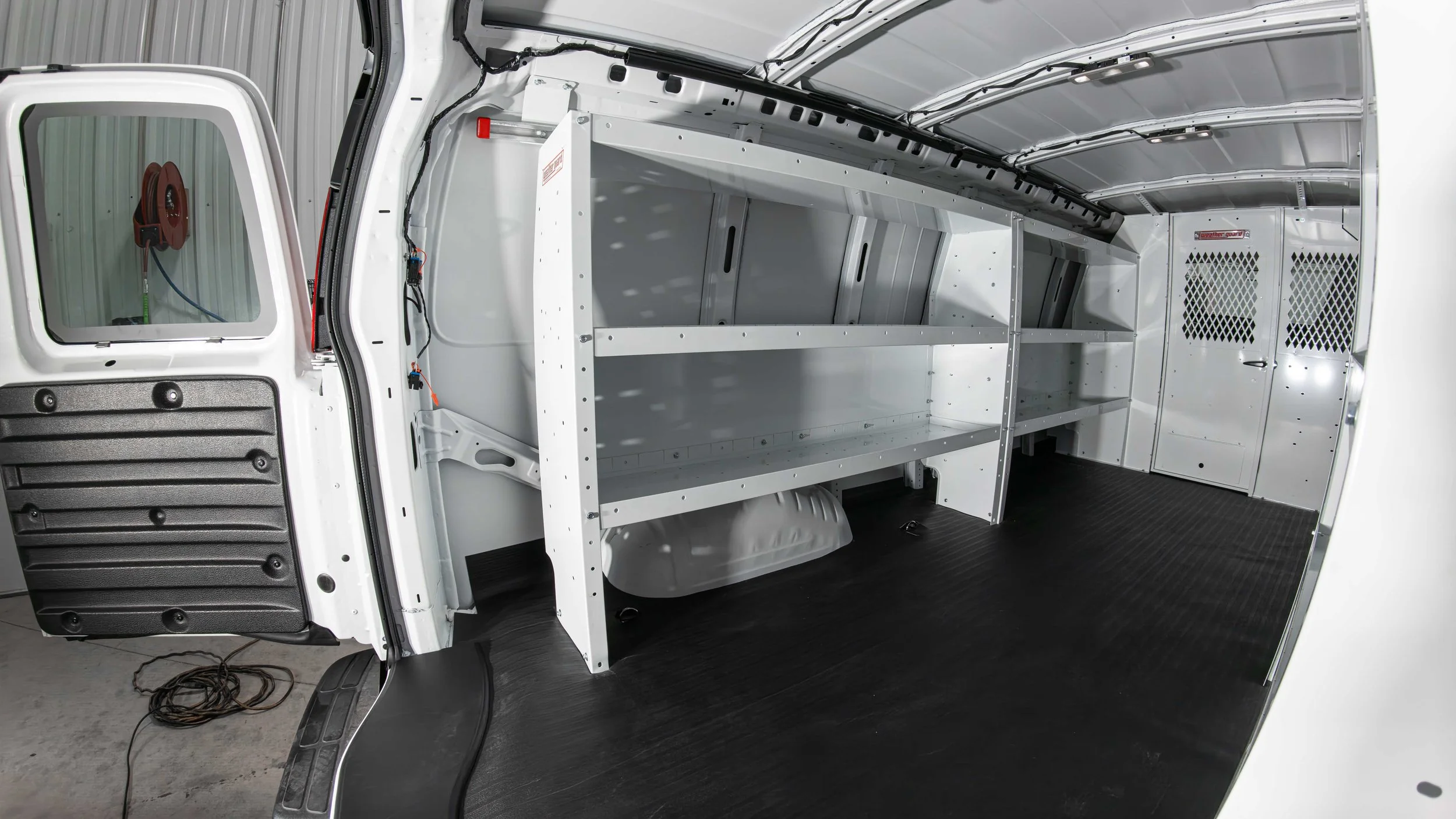 Organized Chevy Express work van interior with a full WeatherGuard van shelving and storage system set up for a Pittsburgh-area contractor