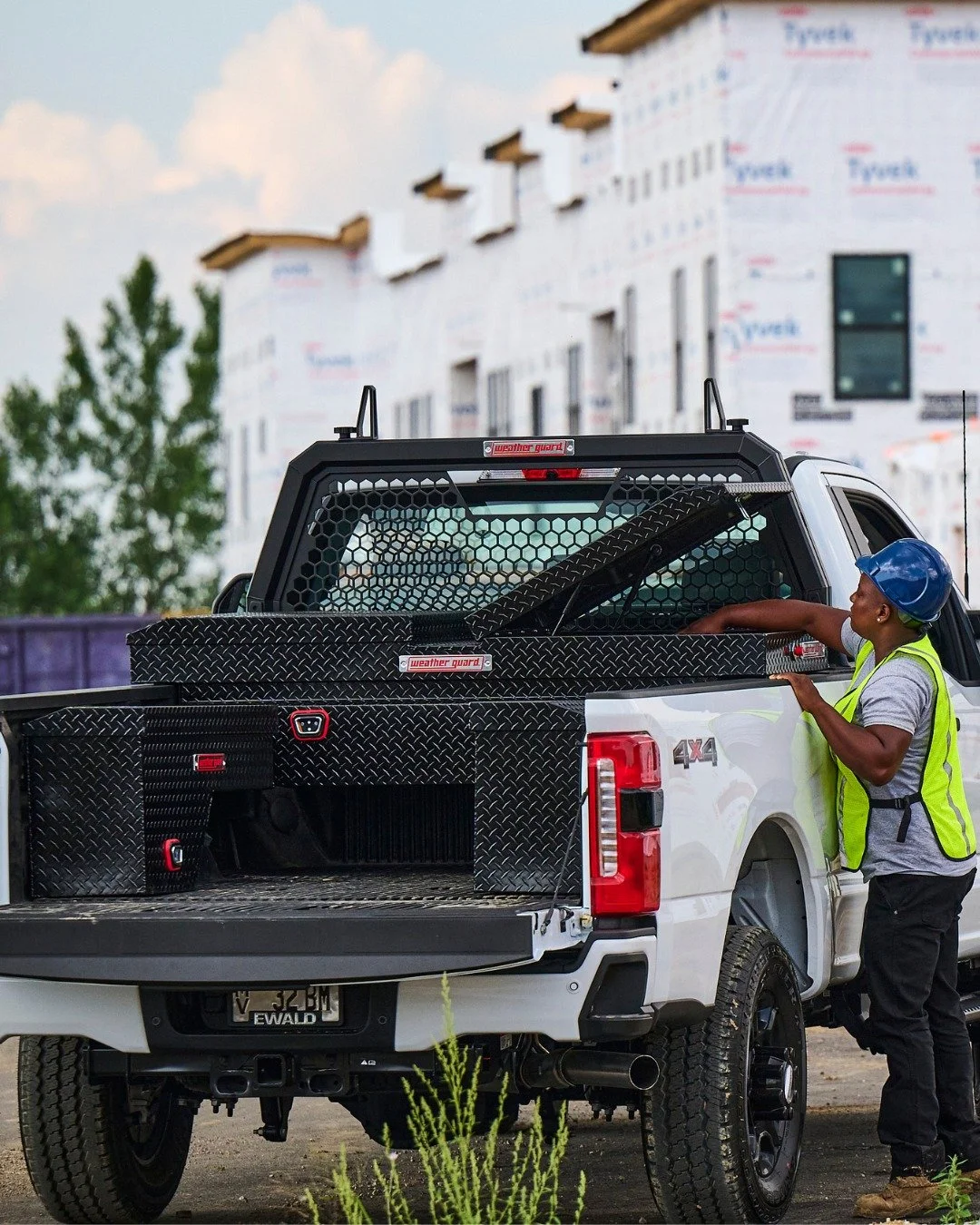 WEATHER GUARD truck toolbox installed on a white work truck with a contractor accessing secure bed storage at Xtreme Car & Truck Accessories near Pittsburgh and the South Hills