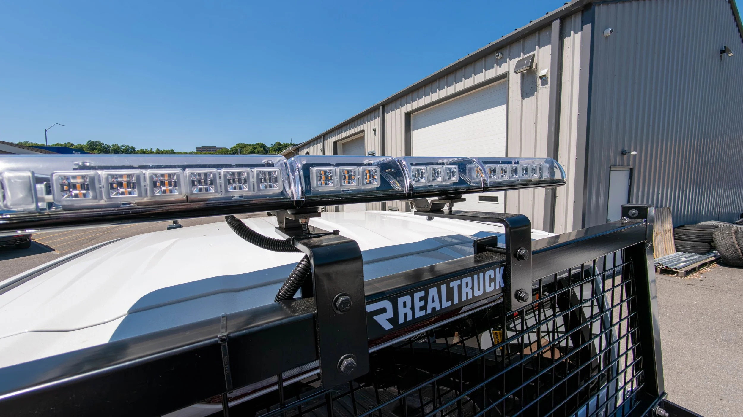 Work truck fitted with amber LED warning lights during a vehicle safety lighting installation at Xtreme Car & Truck Accessories in Bridgeville, PA.