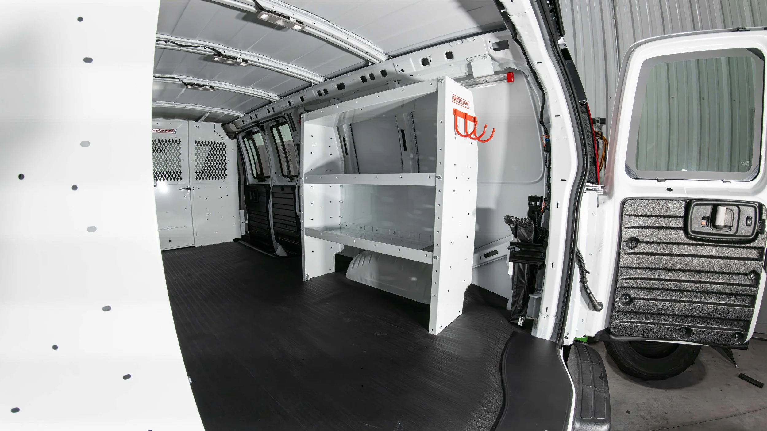 Passenger-side WeatherGuard shelf unit with adjustable shelves inside a Chevy Express work van