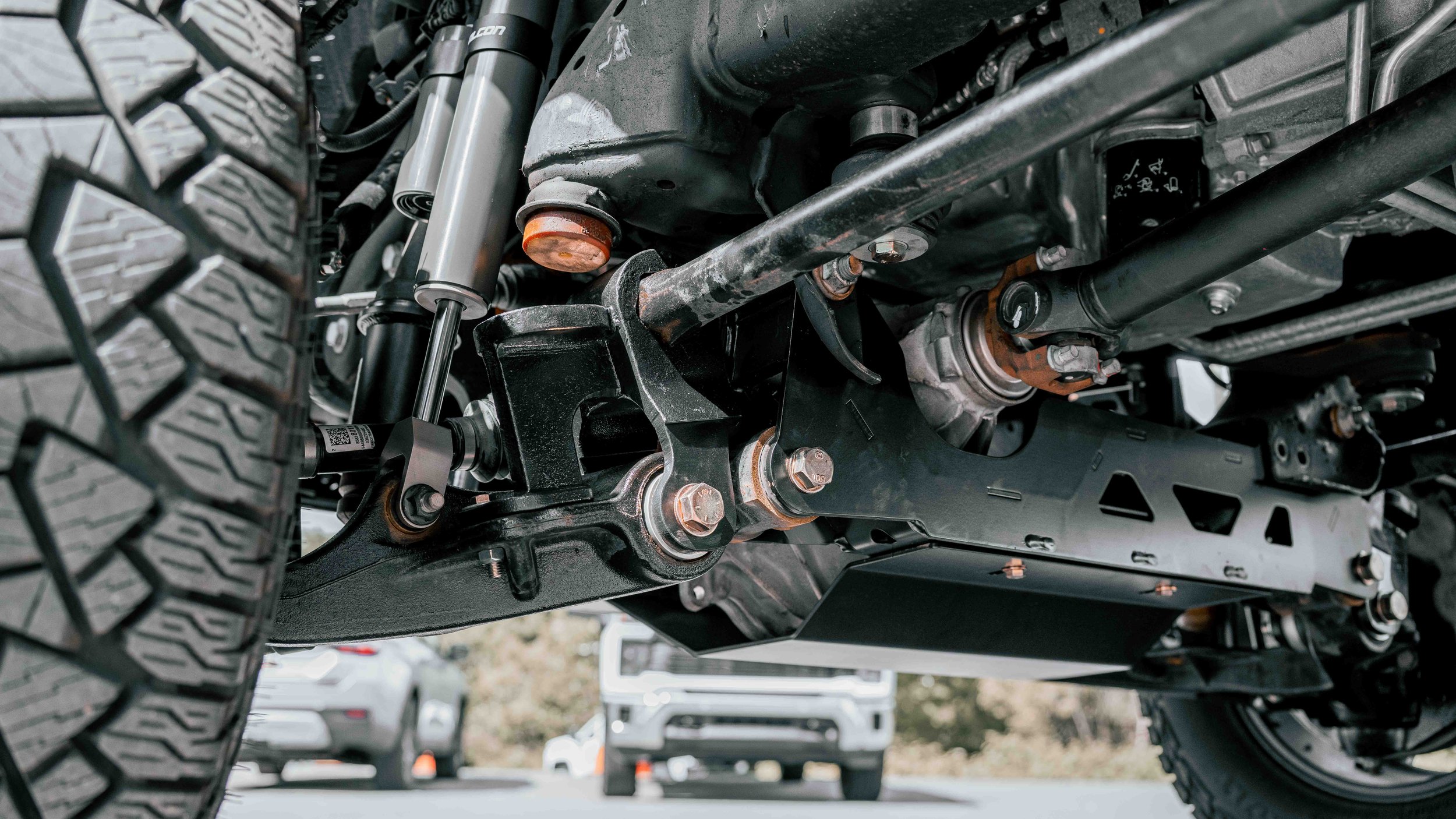 Undercarriage view of ReadyLIFT lift components and Falcon shock on a lifted GMC Sierra in Bridgeville, PA.